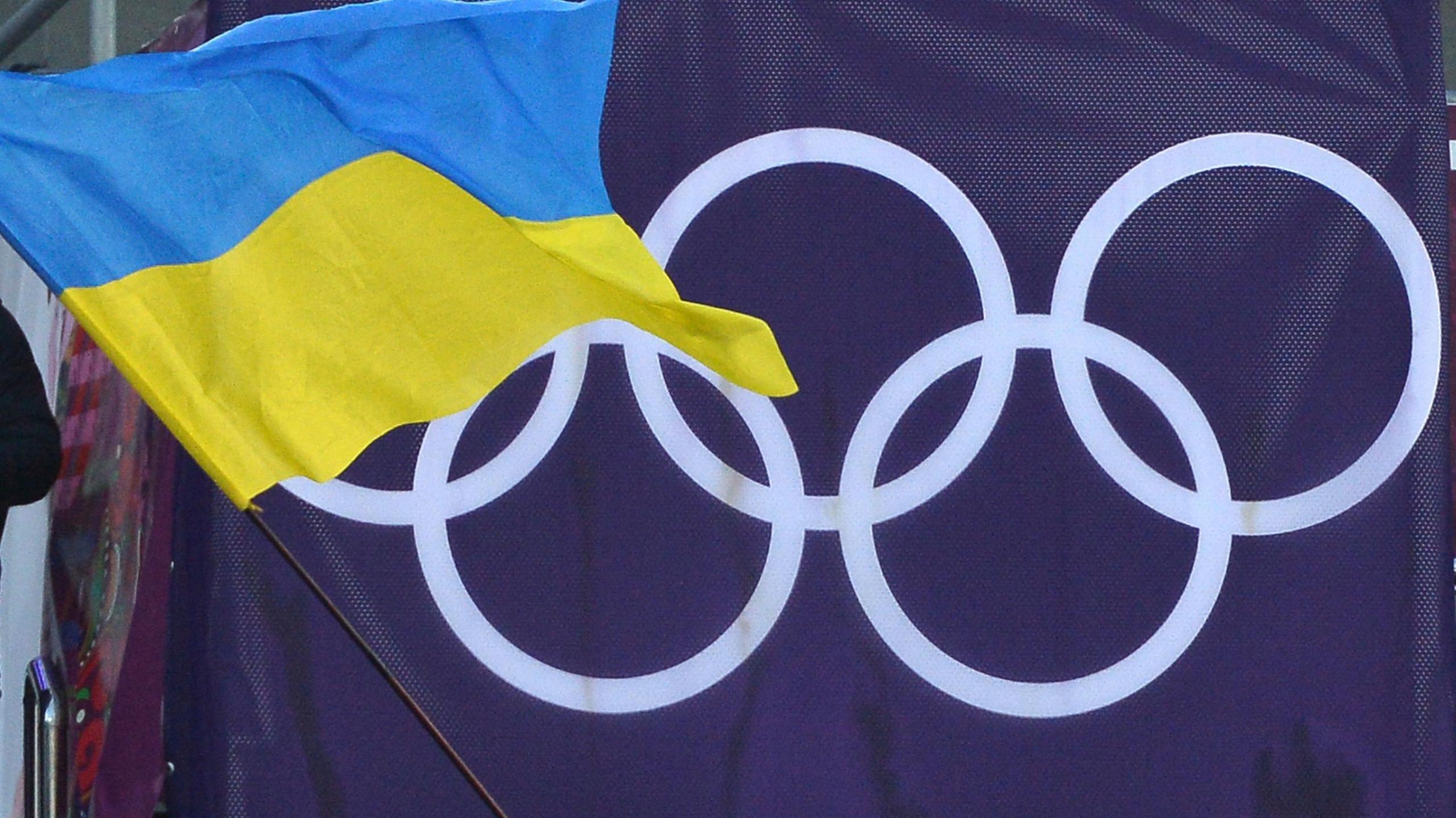 Ukraine flag in front of the Olympic rings