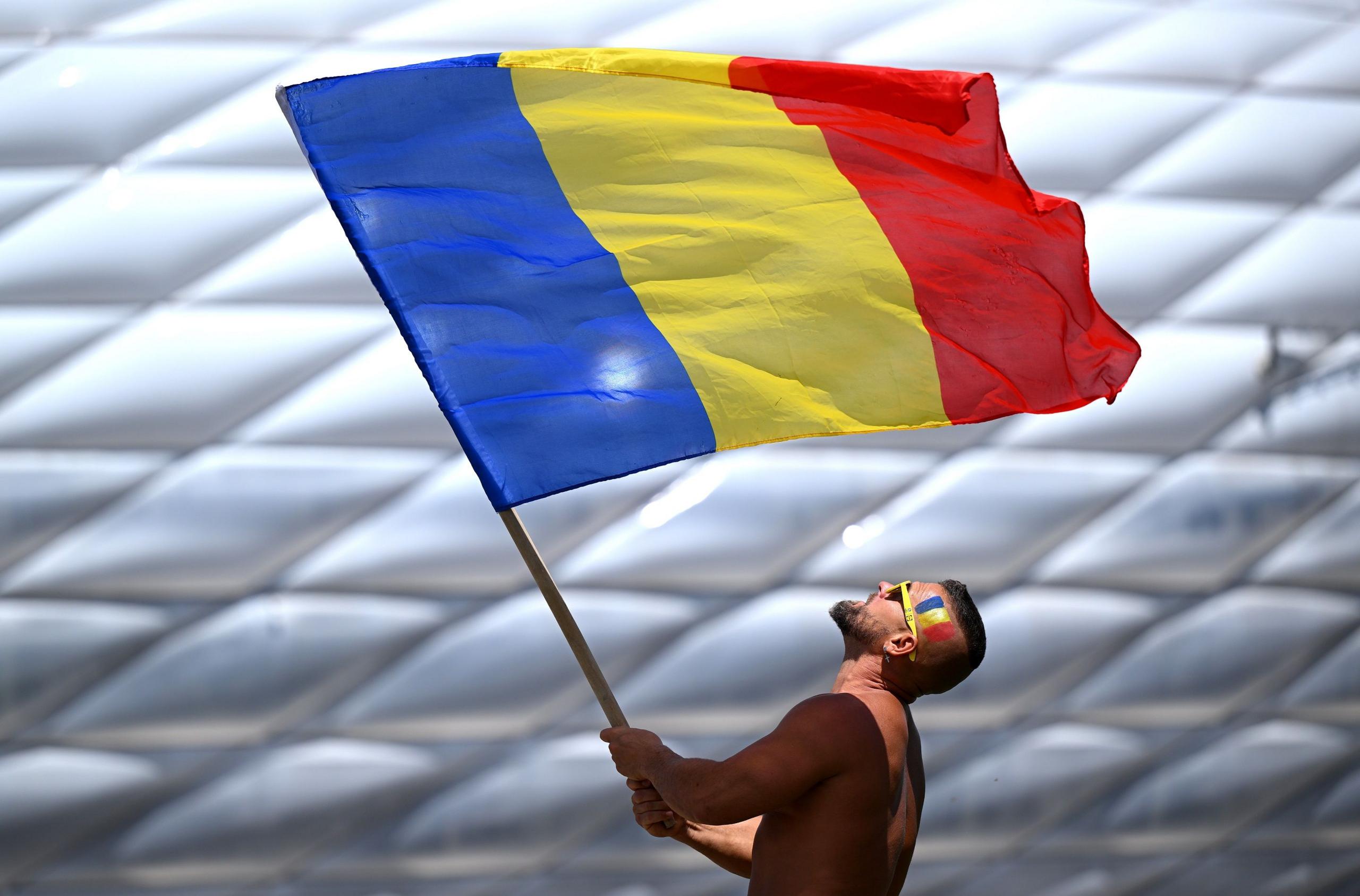 A supporter waves a Romanian flag before the Euro 2024 group game against Ukraine in Munich