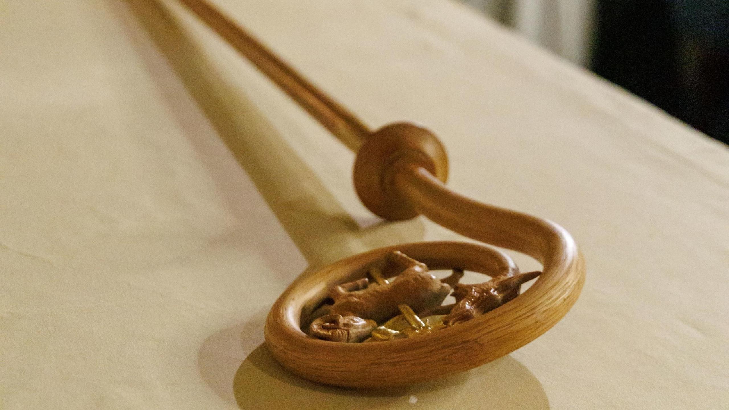 The ornately carved wooden crook of the Archbishop of Canterbury laid on an altar