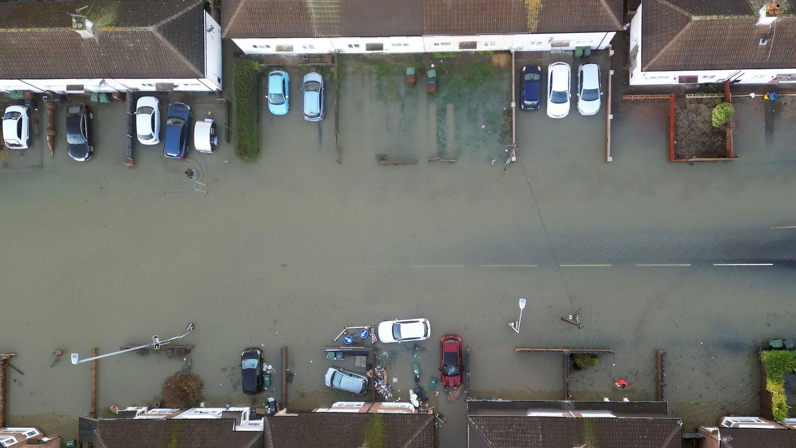 An aerial photograph of houses and homes surrounded by flood water