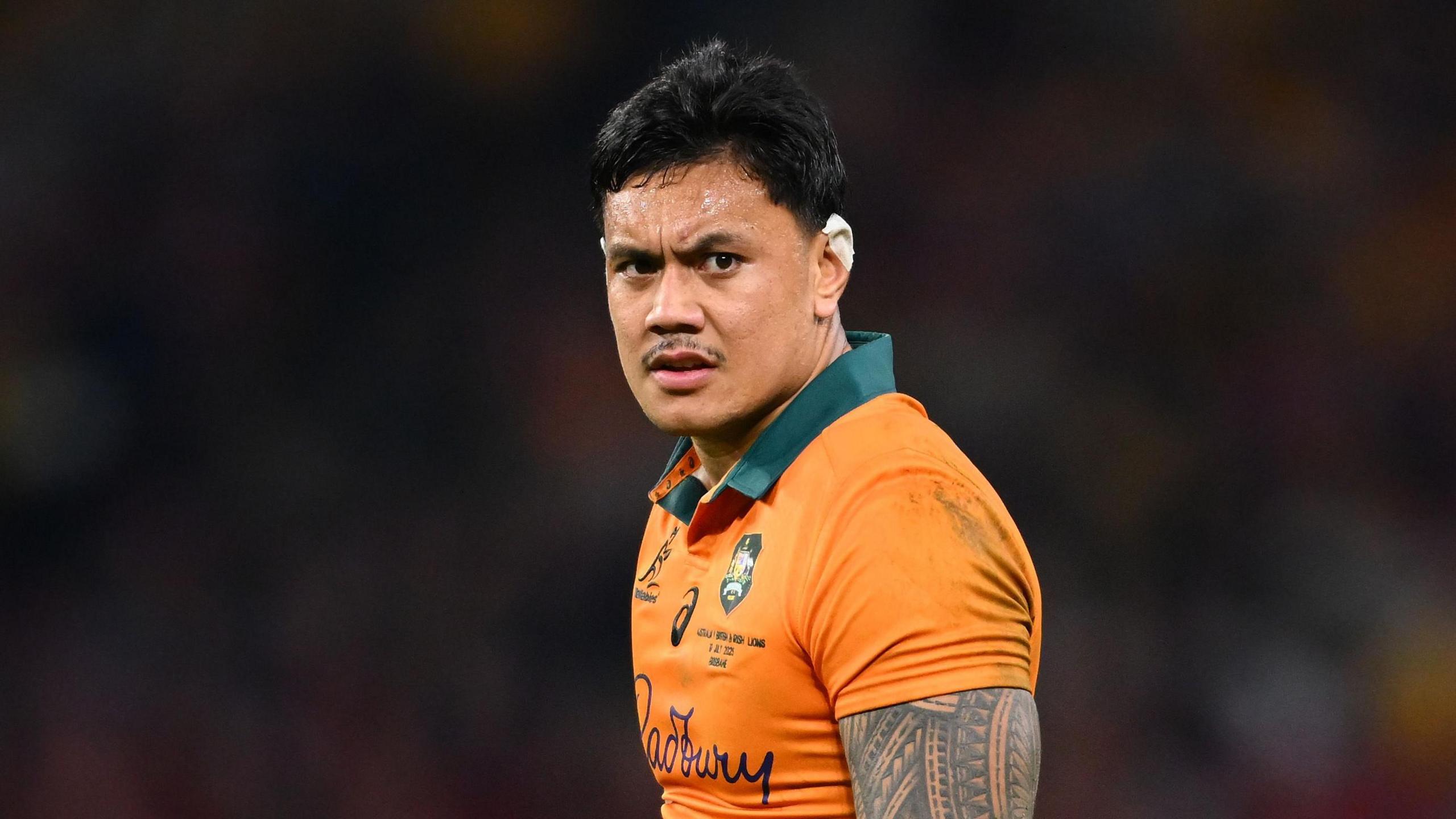 Len Ikitau standing on the pitch