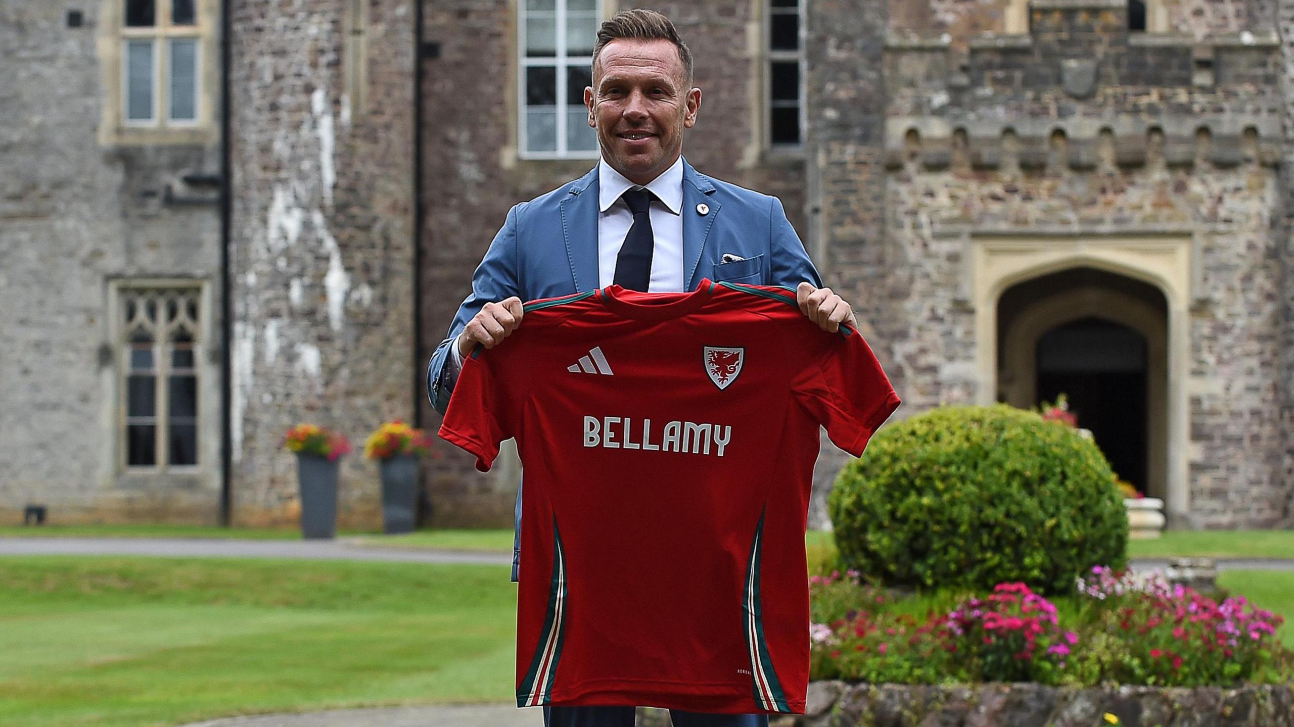 Craig Bellamy holds up Wales shirt with his name on