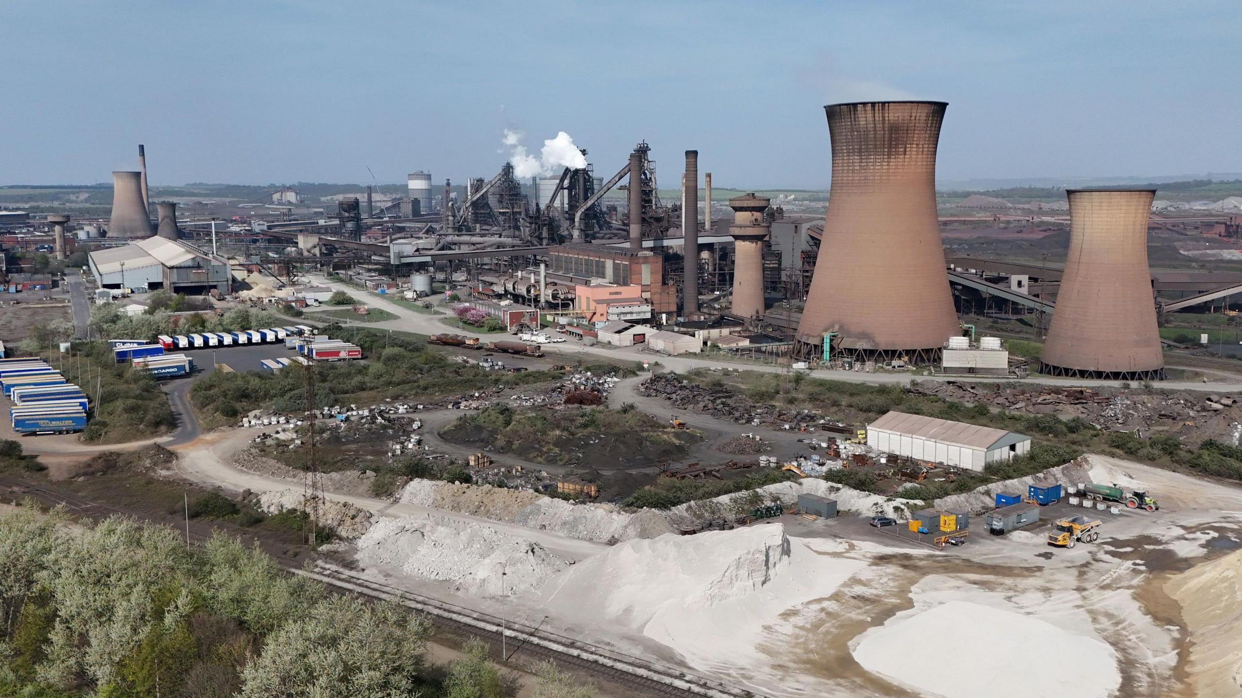 An aeral view of the steel plant in Scunthorpe, showing the cooling towers and other industrial chimneys.