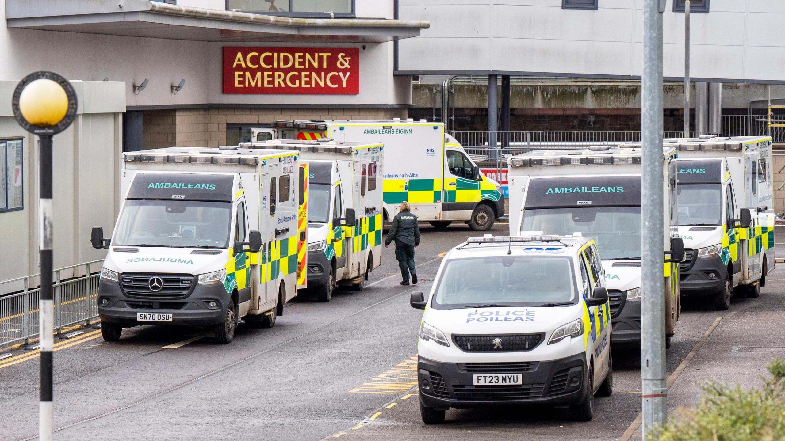 Ambulances and a police van line up on two sides of the road outside the Accident and Emergency Department at the Victoria Hospital in Kirkcaldy, Fife.