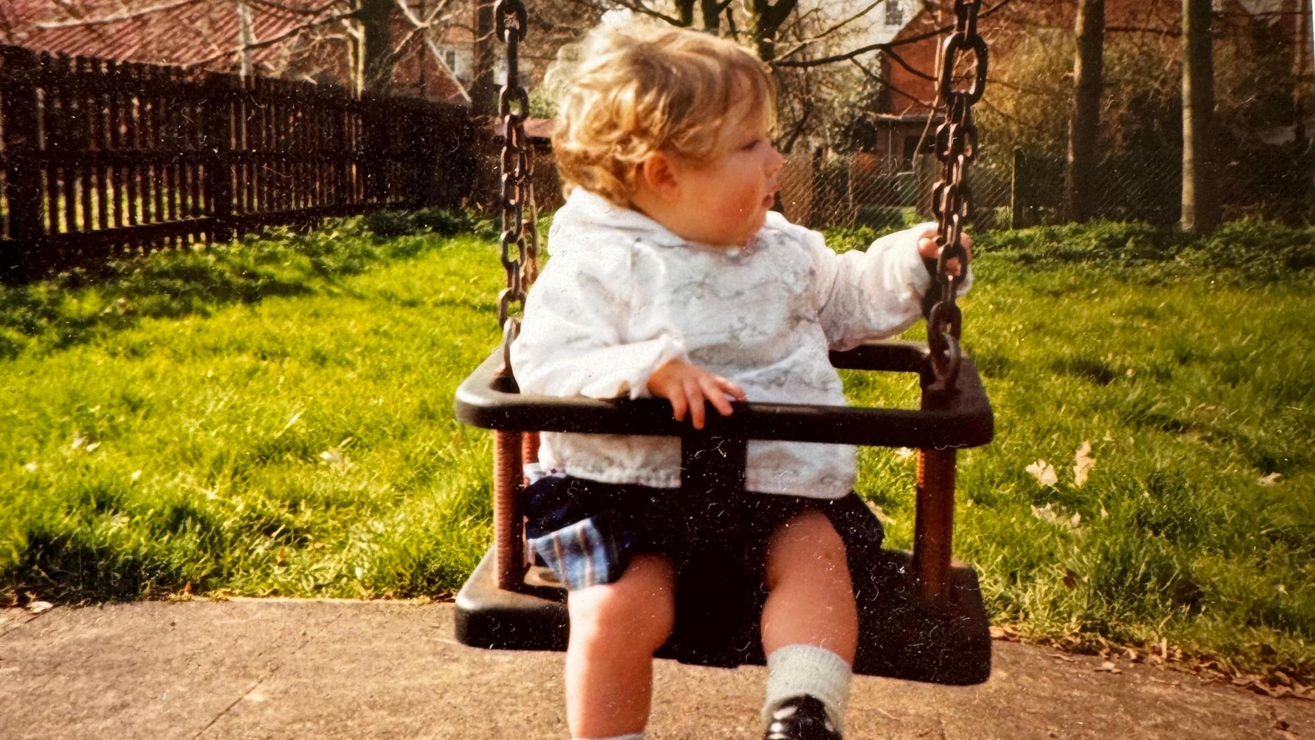 Young Alana on a swing