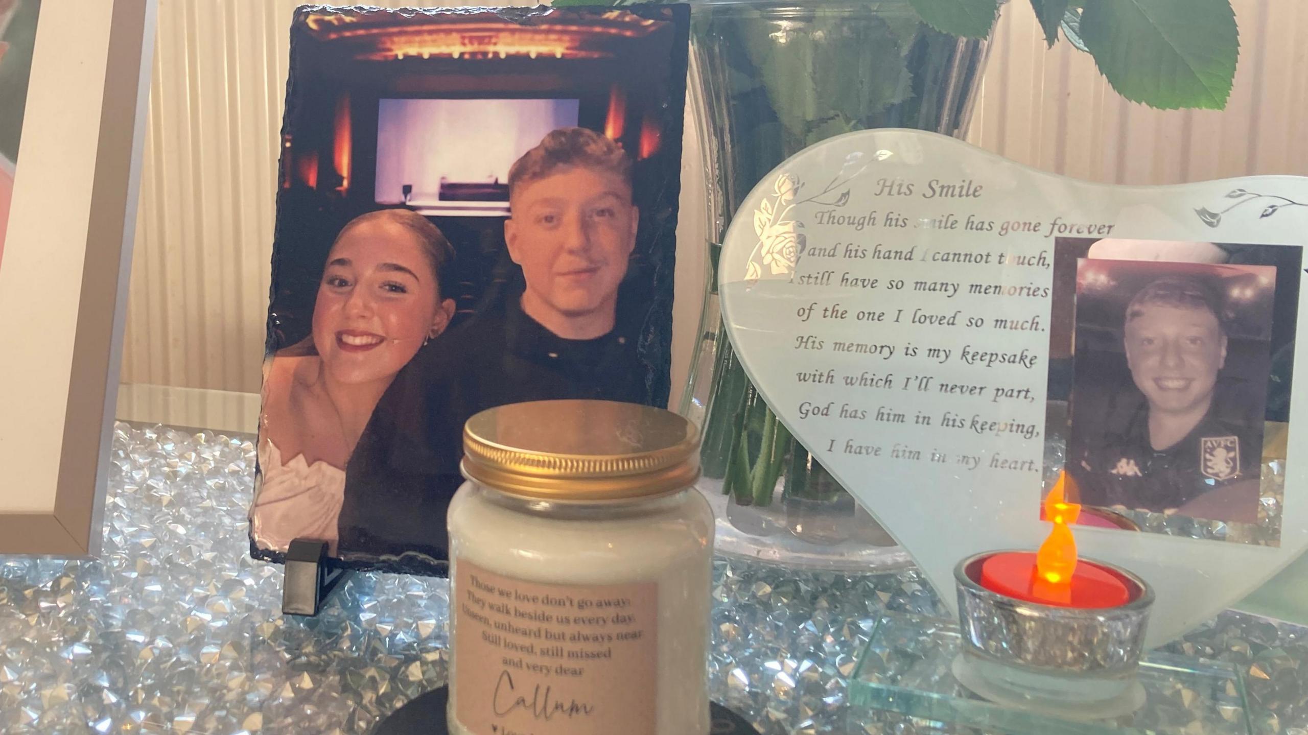 A photo of Erin and Callum Griffiths with candles and a poem are just some of the many memories of Callum now in his family home.