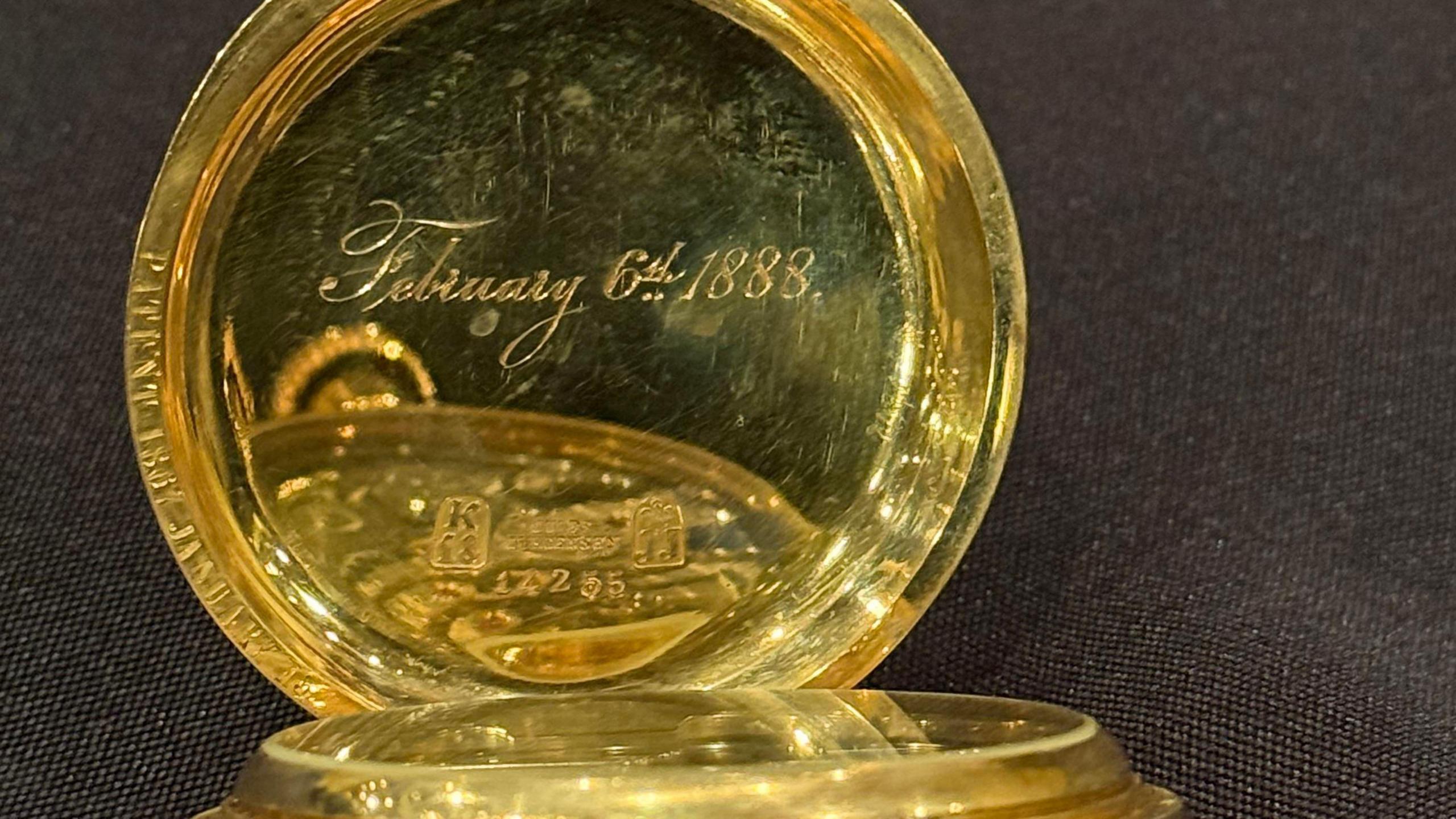 A golden watch engraved on the inside with February 6th 1888.
