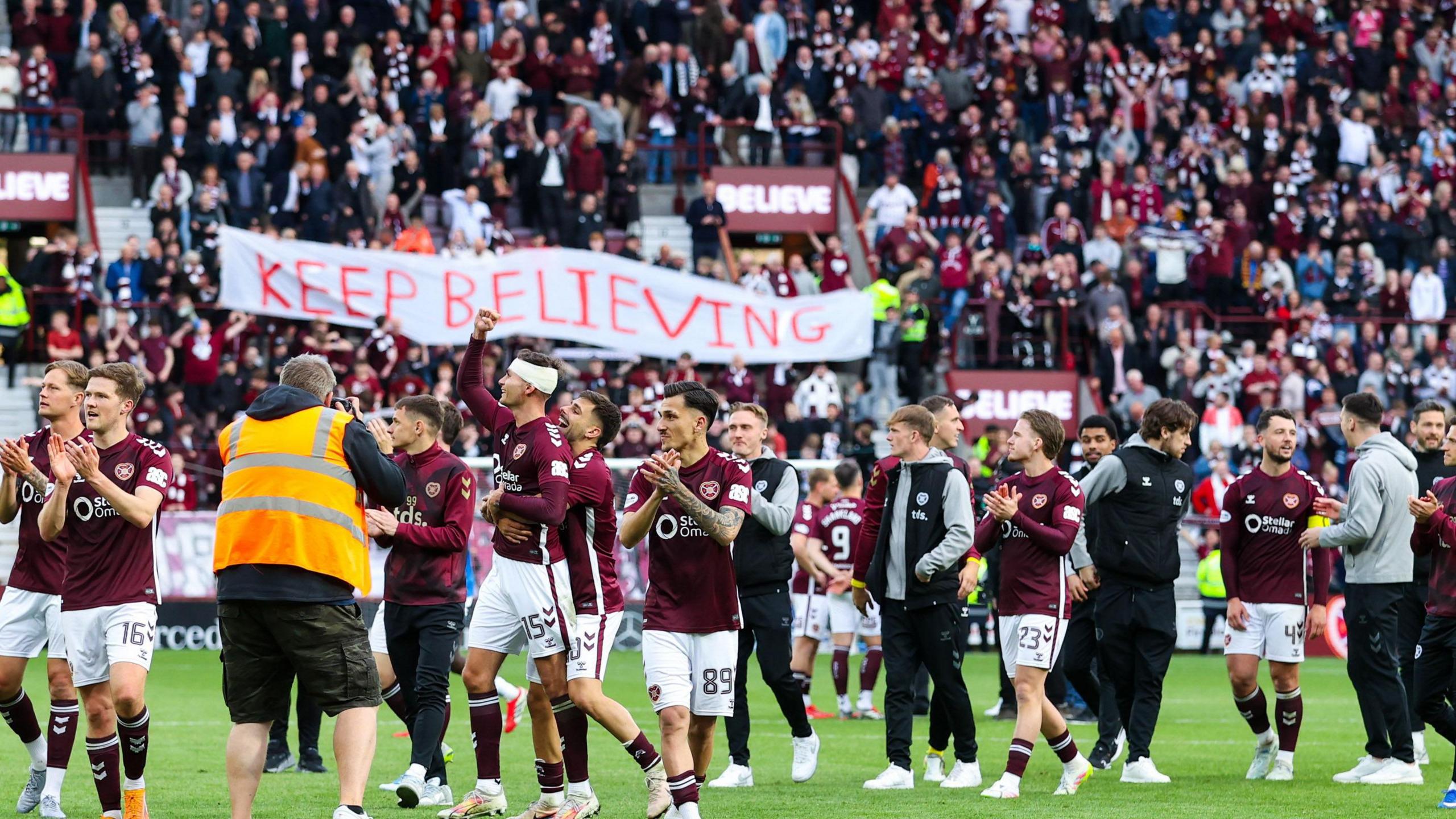 Hearts fans and players celebrate at full-time