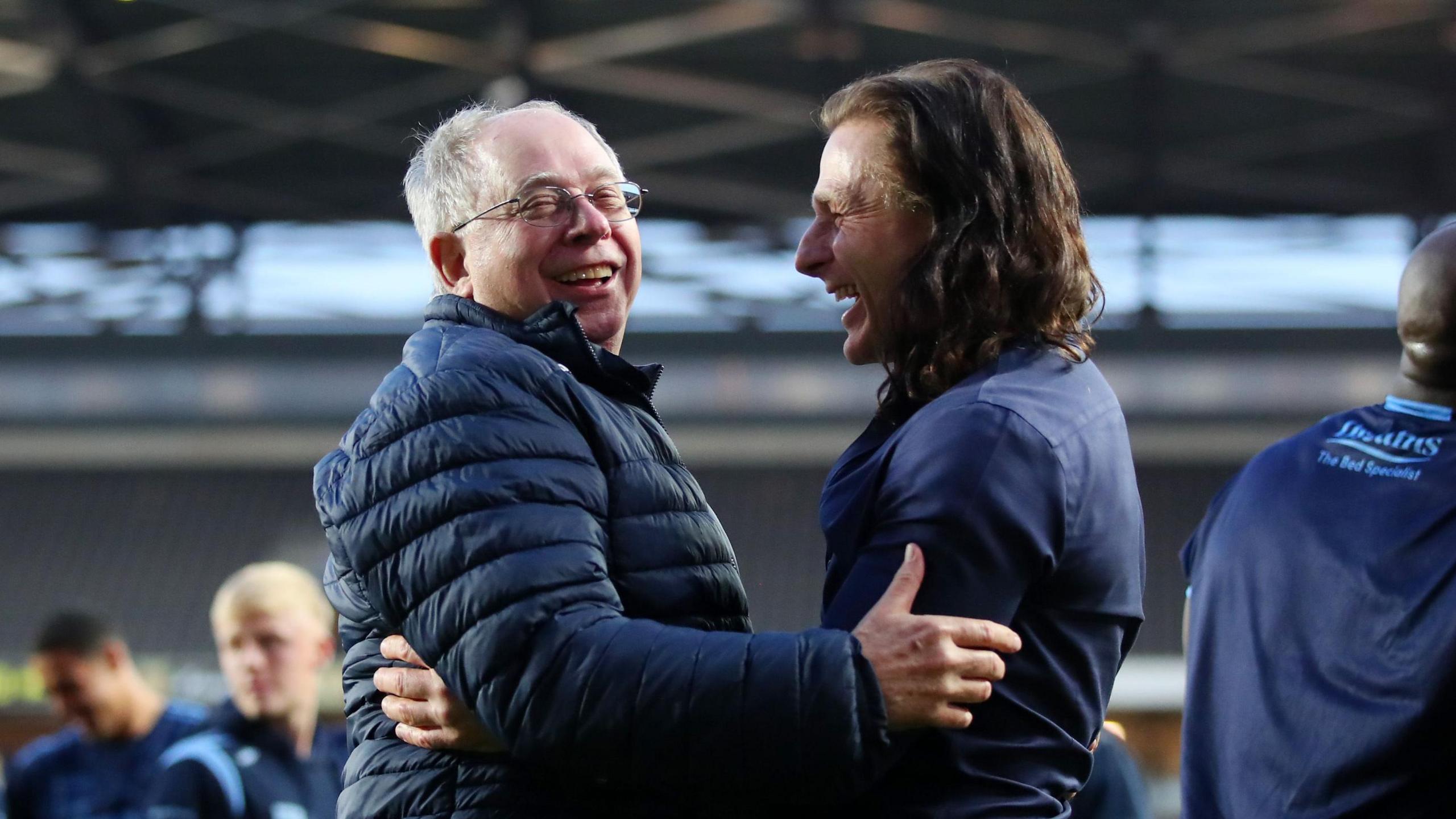 Then-Wycombe Wanderers owner Rob Couhig embracing then-boss Gareth Ainsworth after a League One semi-final play-off win in 2022