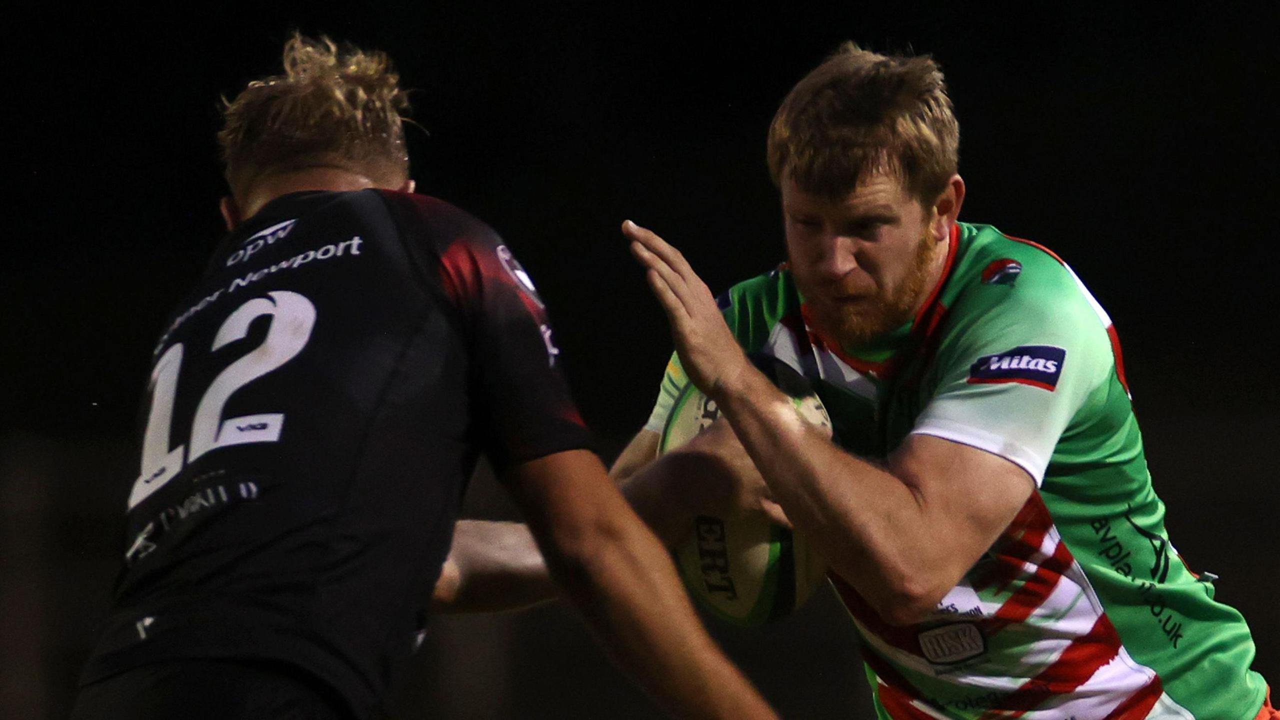 Aaron Warren of Llandovery is tackled by Joel Mahoney of Pontypool