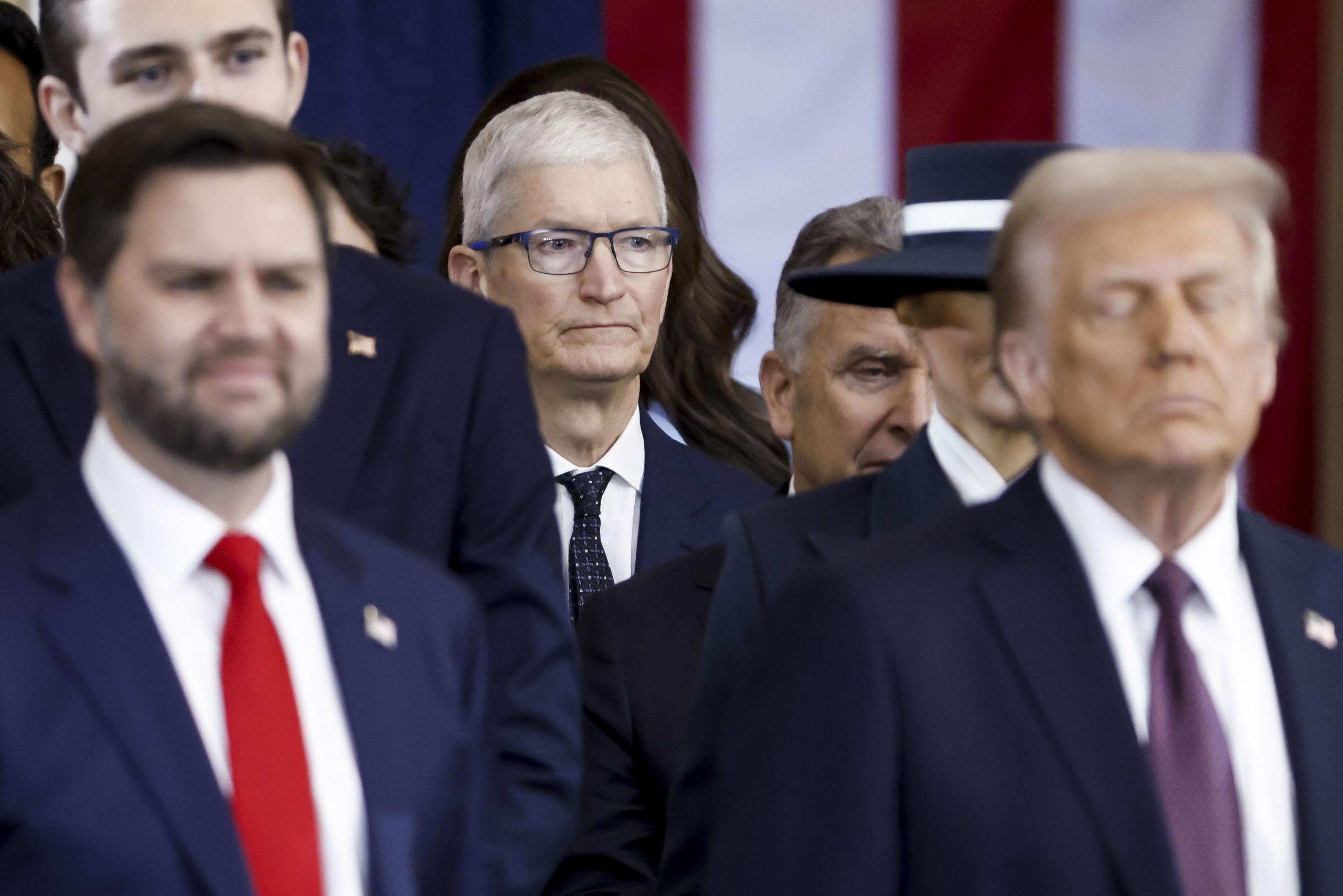 Tim Cook standing behind JD Vance and Donald Trump