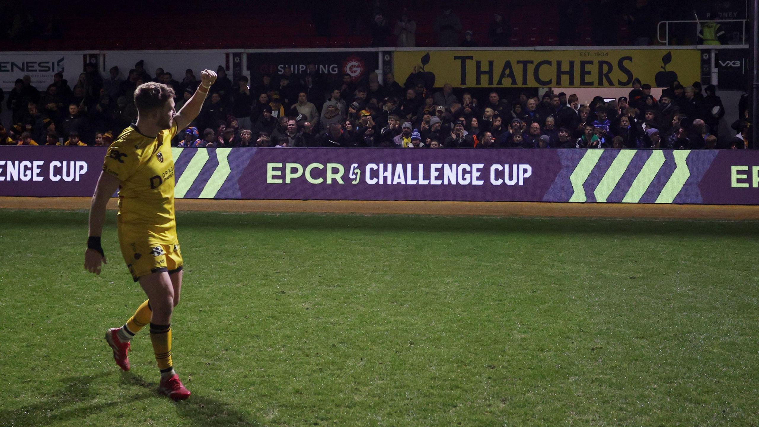 Angus O'Brien celebrates with the Dragons supporters at Rodney Parade after the win against Newcastle