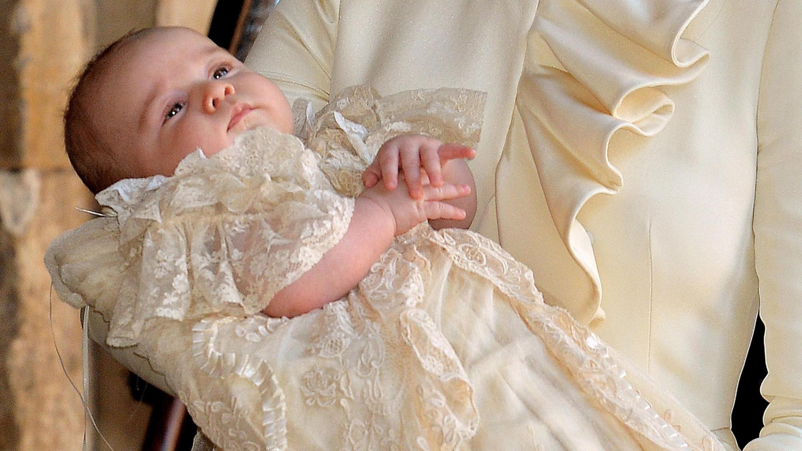 A baby Prince George in a cream outfit during his christening in 2013 