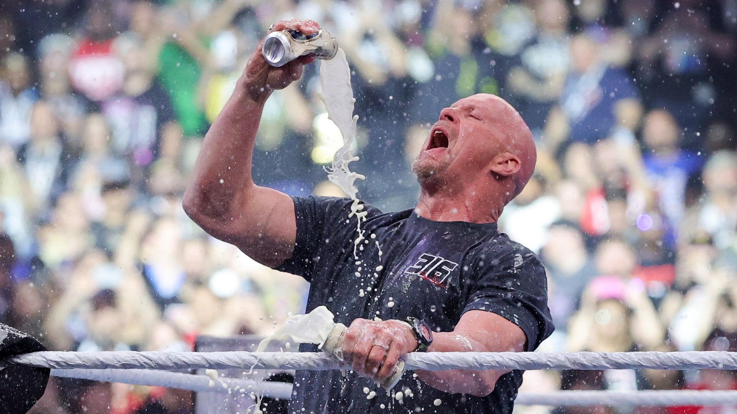 Steve Austin drinks a beer during a WWE event