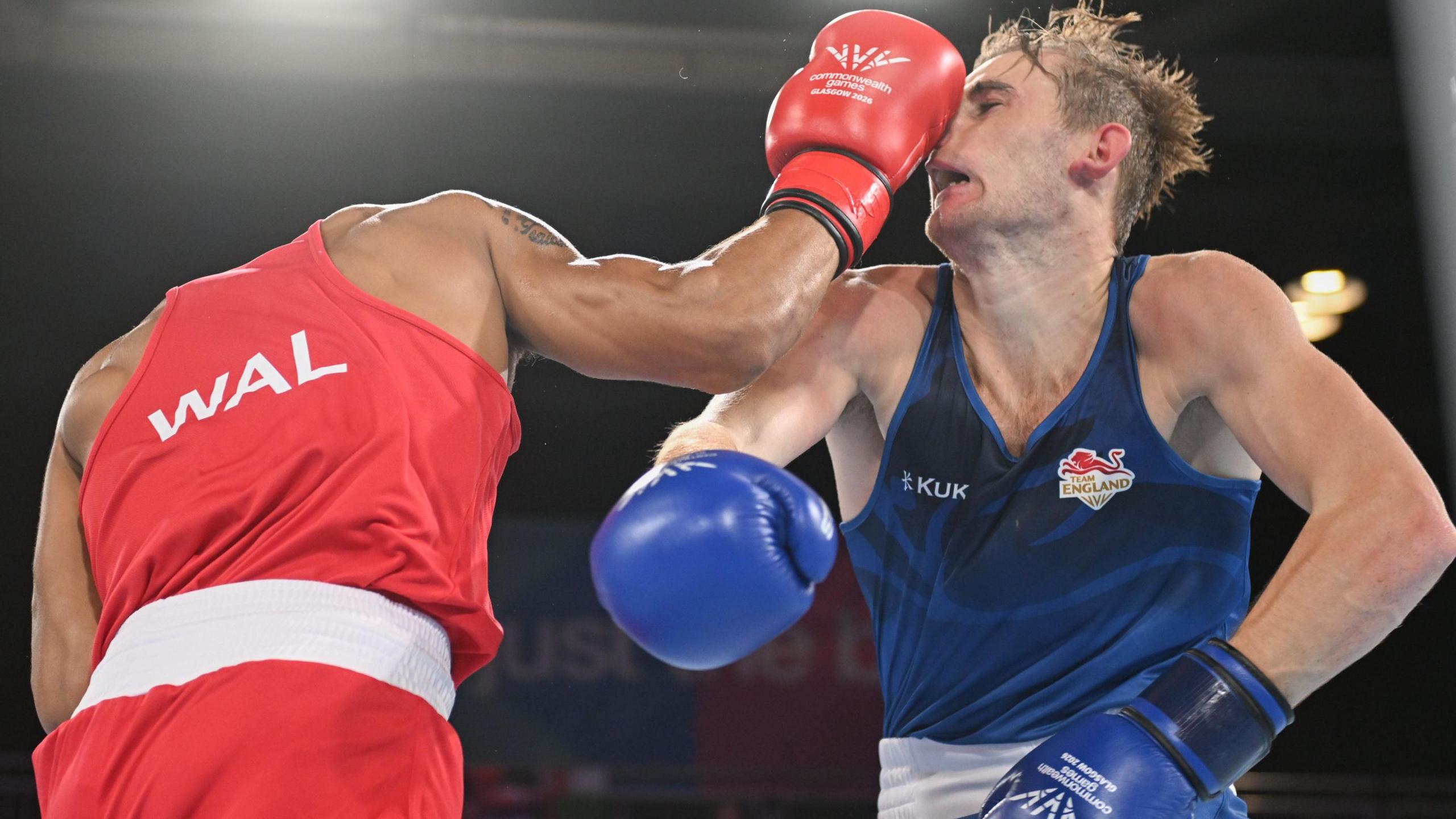 Boxer Orlando Holley-Sotomi punches England's Paddy Hewitt