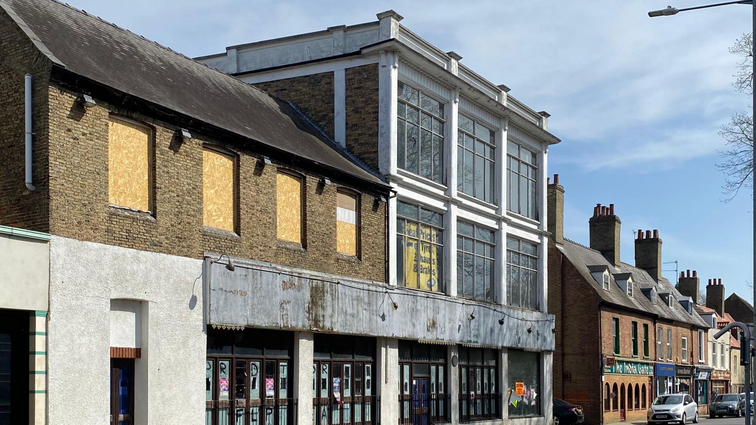 A general view of the building, showing that it is on a busy King's Lynn street.