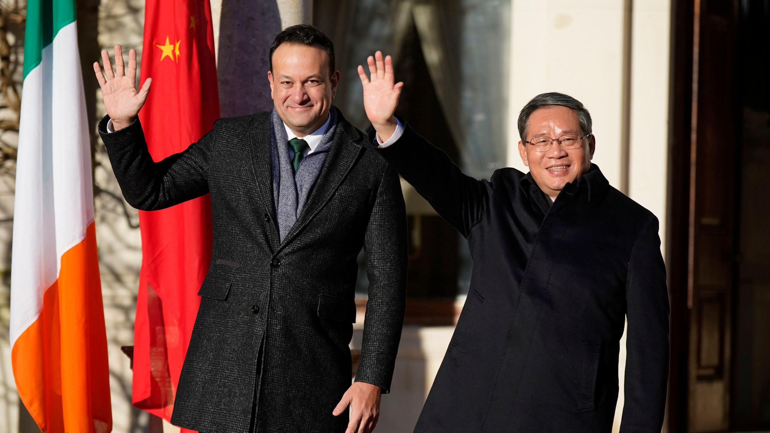 Taoiseach Leo Varadkar stands and Chinese premier Li Qiang standing and waving