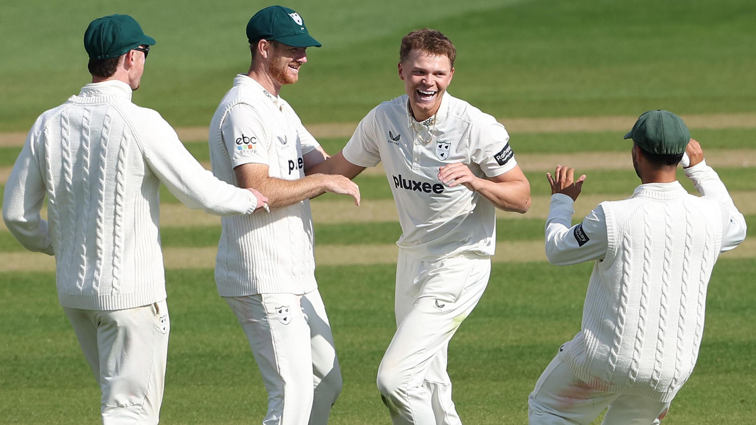 Ethan Brookes celebrates with his Worcestershire team-mates after taking a wicket