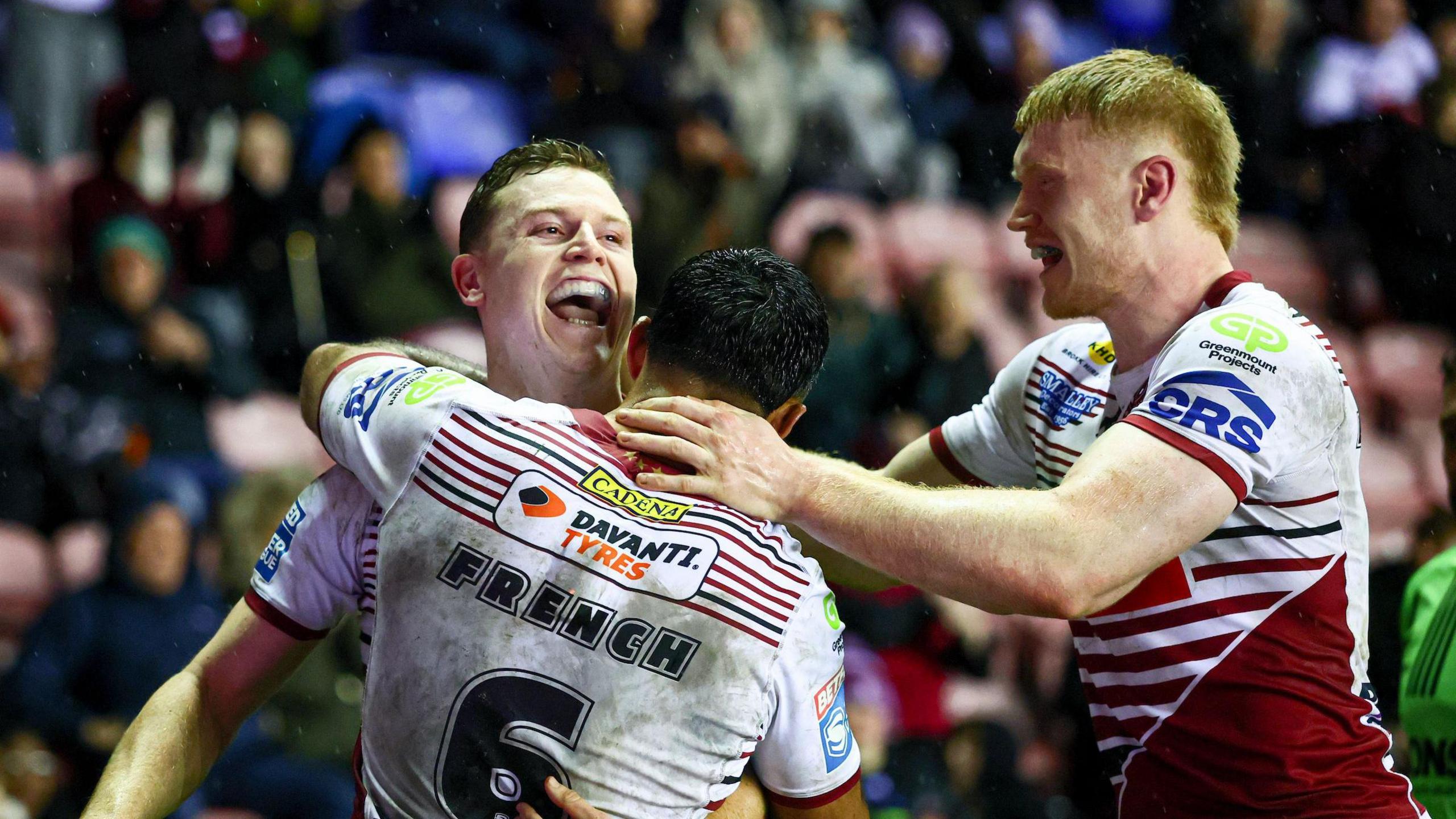 Jay Field celebrates scoring Wigan's sixth try with his team-mates