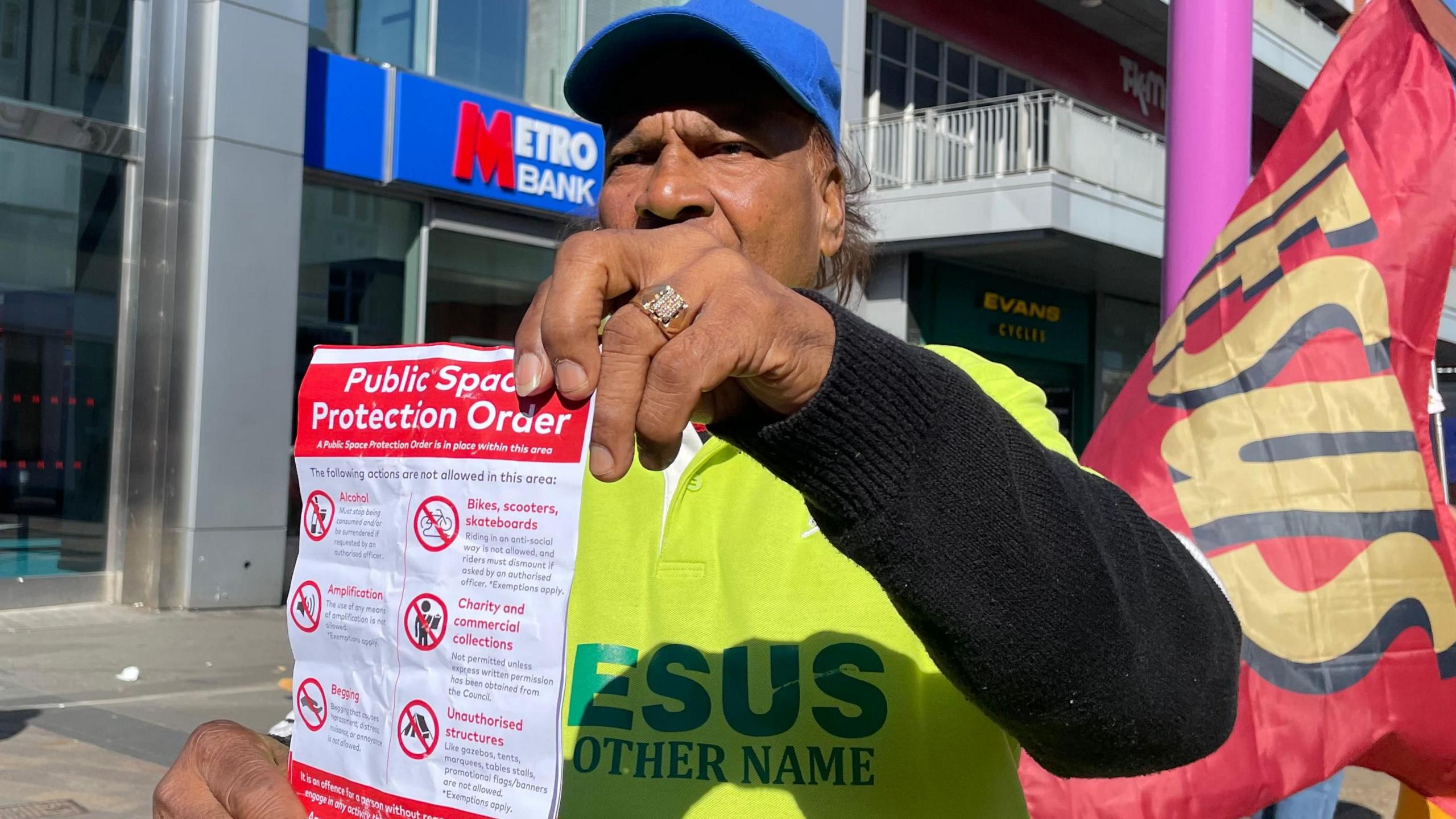Rev Don Balkaran holding a copy of the new Public Space Protection Order in Leicester city centre