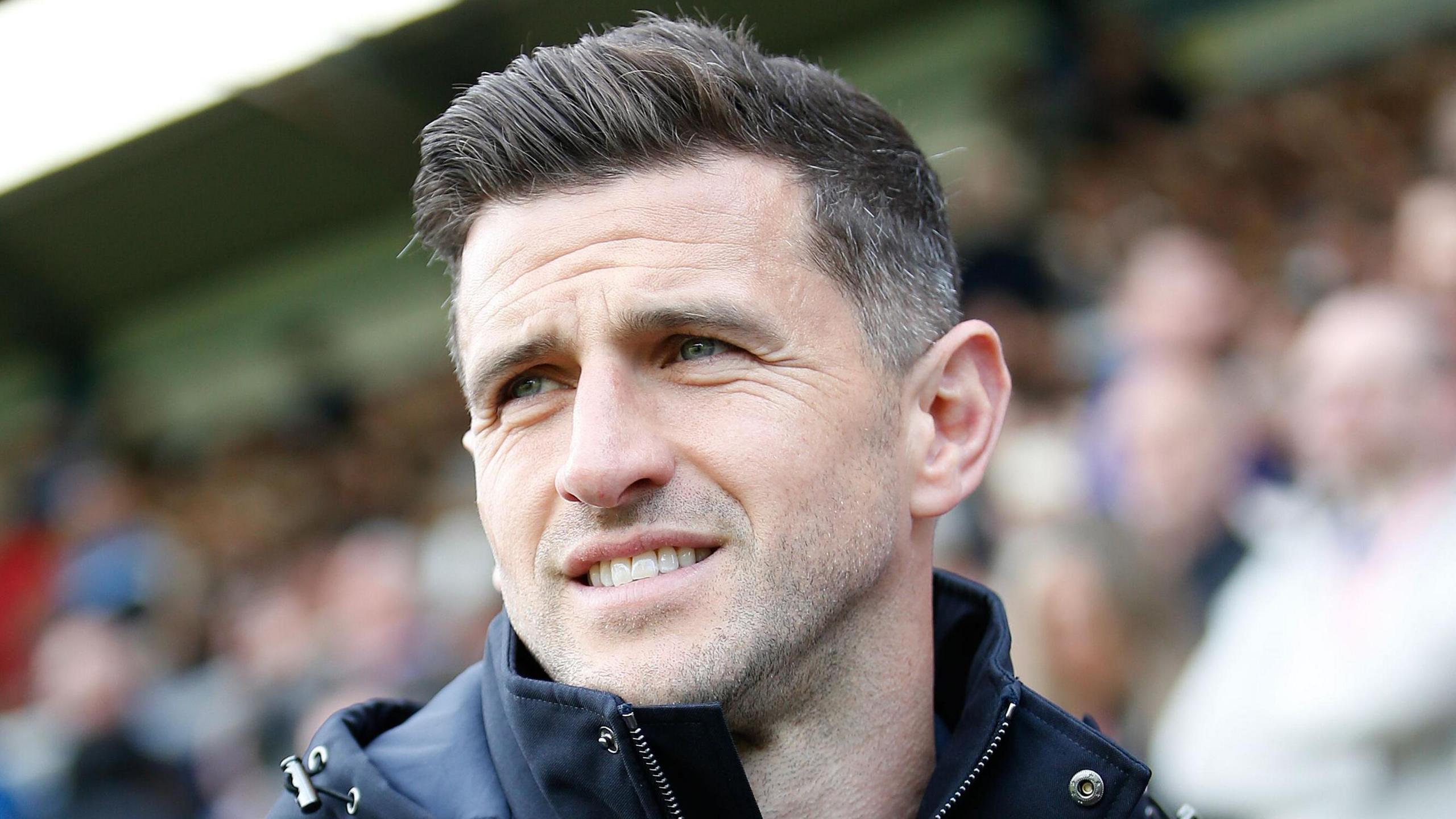 A smiling Portsmouth boss John Mousinho