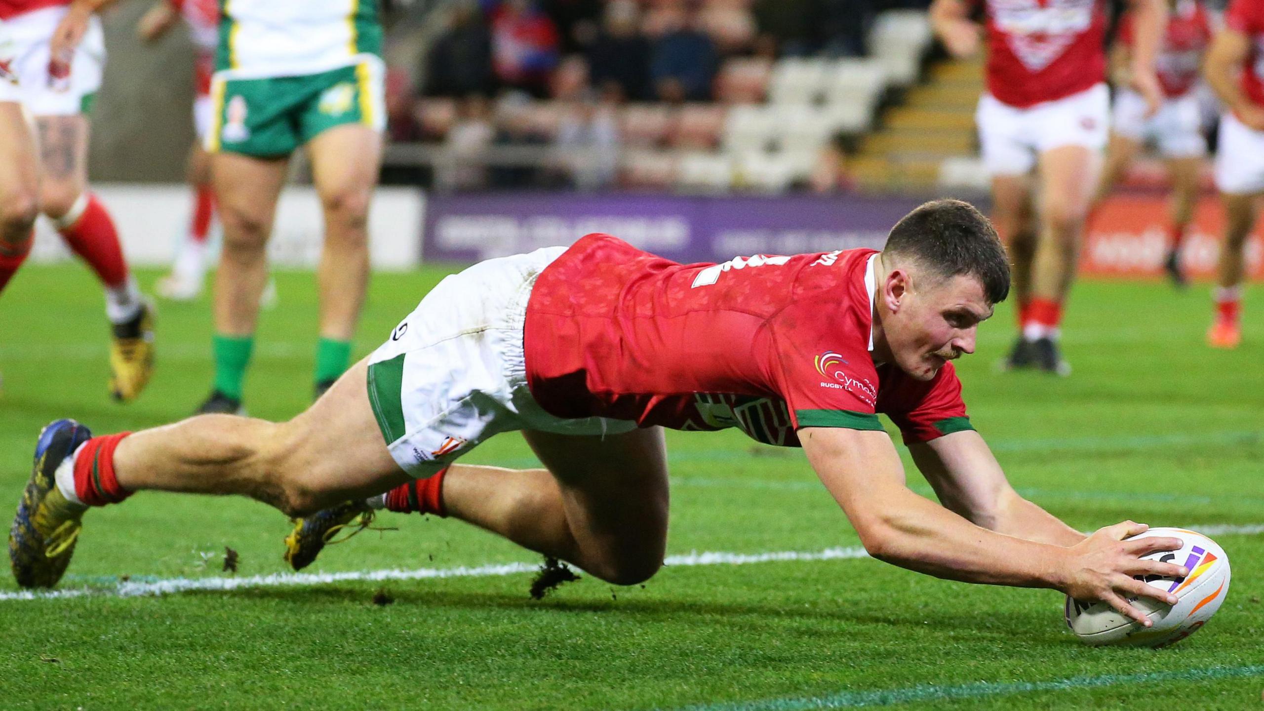 Rhodri Lloyd crosses for a try for Wales against Cook Islands at the Rugby League World Cup in 2022