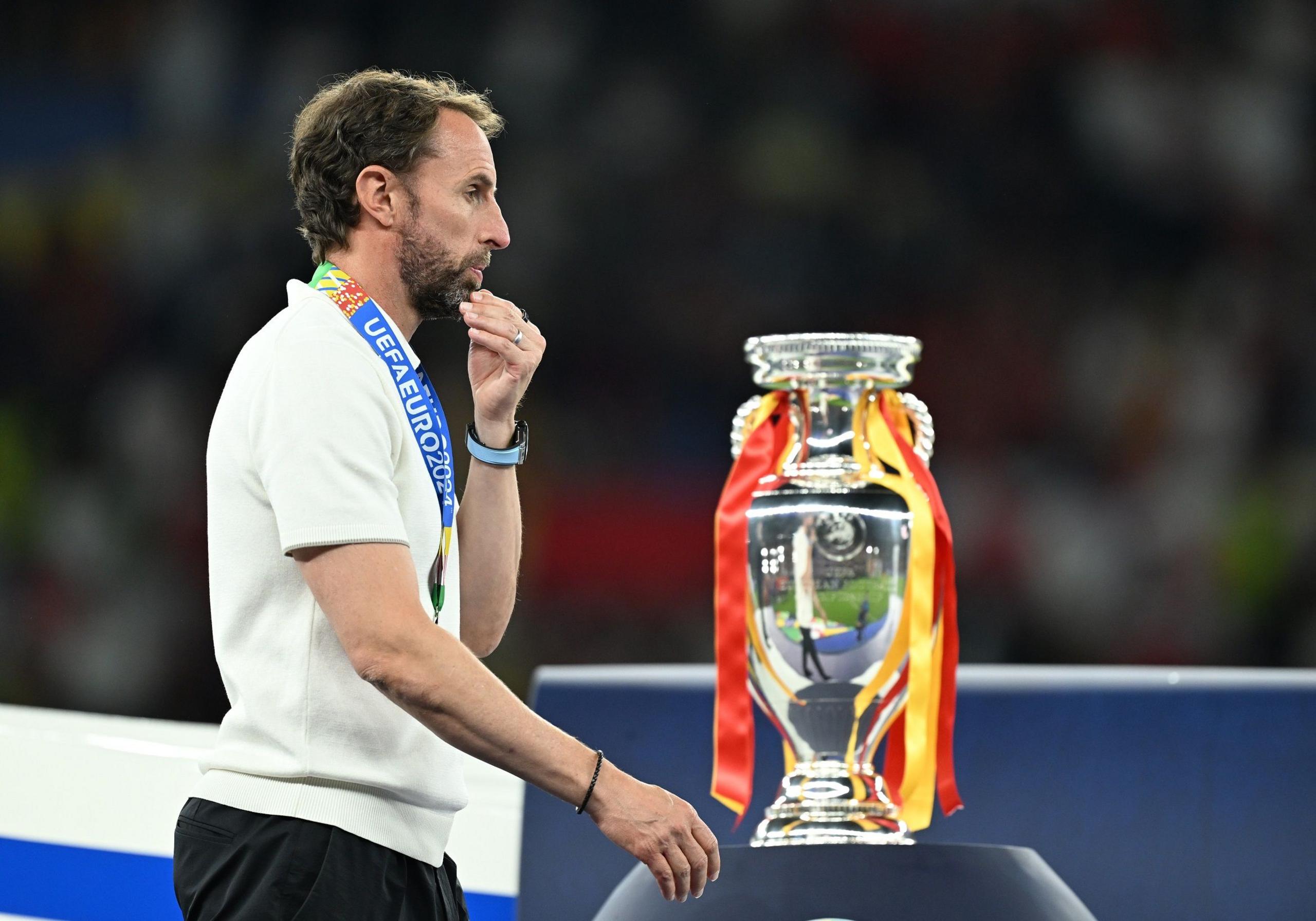 England manager Gareth Southgate walks past the Euro 2024 trophy following the defeat by Spain in the final