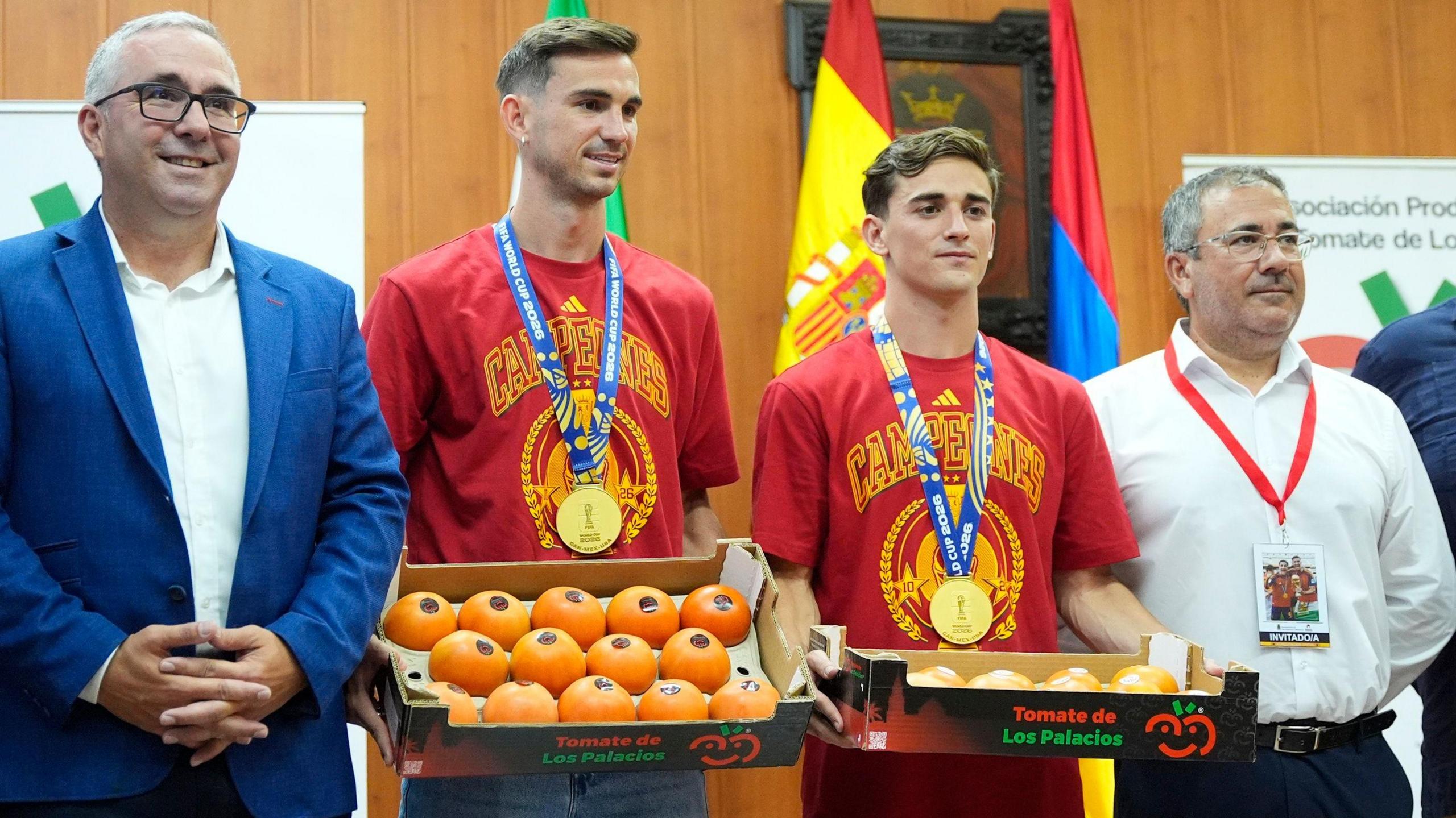 Spain midfielders Fabian Ruiz and Gavi holding a box of tomatoes on a visit back to the hometown of Los Palacios y Villafranca