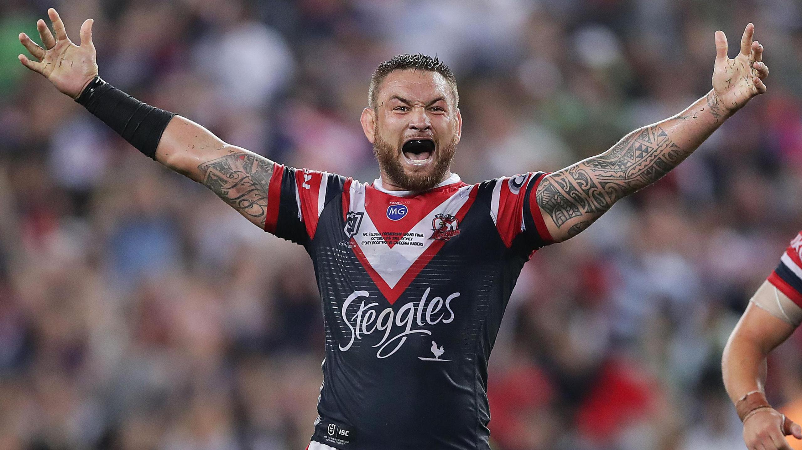 Jared Waerea-Hargreaves stands with arms outstretched and roars in delight after the hooter sounds for Sydney Roosters to confirm they have won the 2019 NRL Grand Final