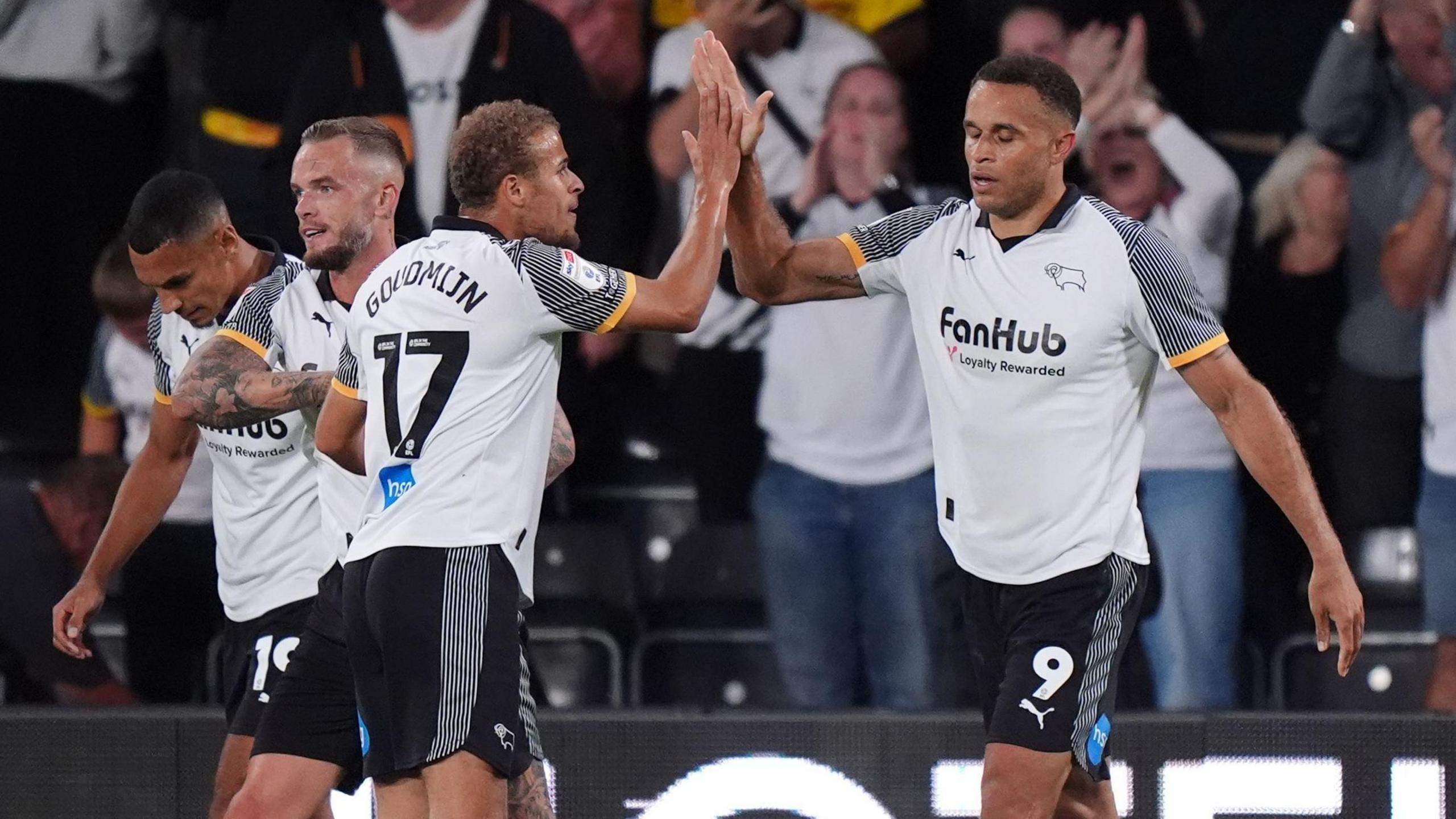 Carlton Morris (right) holds one hand up to high five team-mate Kenzo Goudmijn after scoring