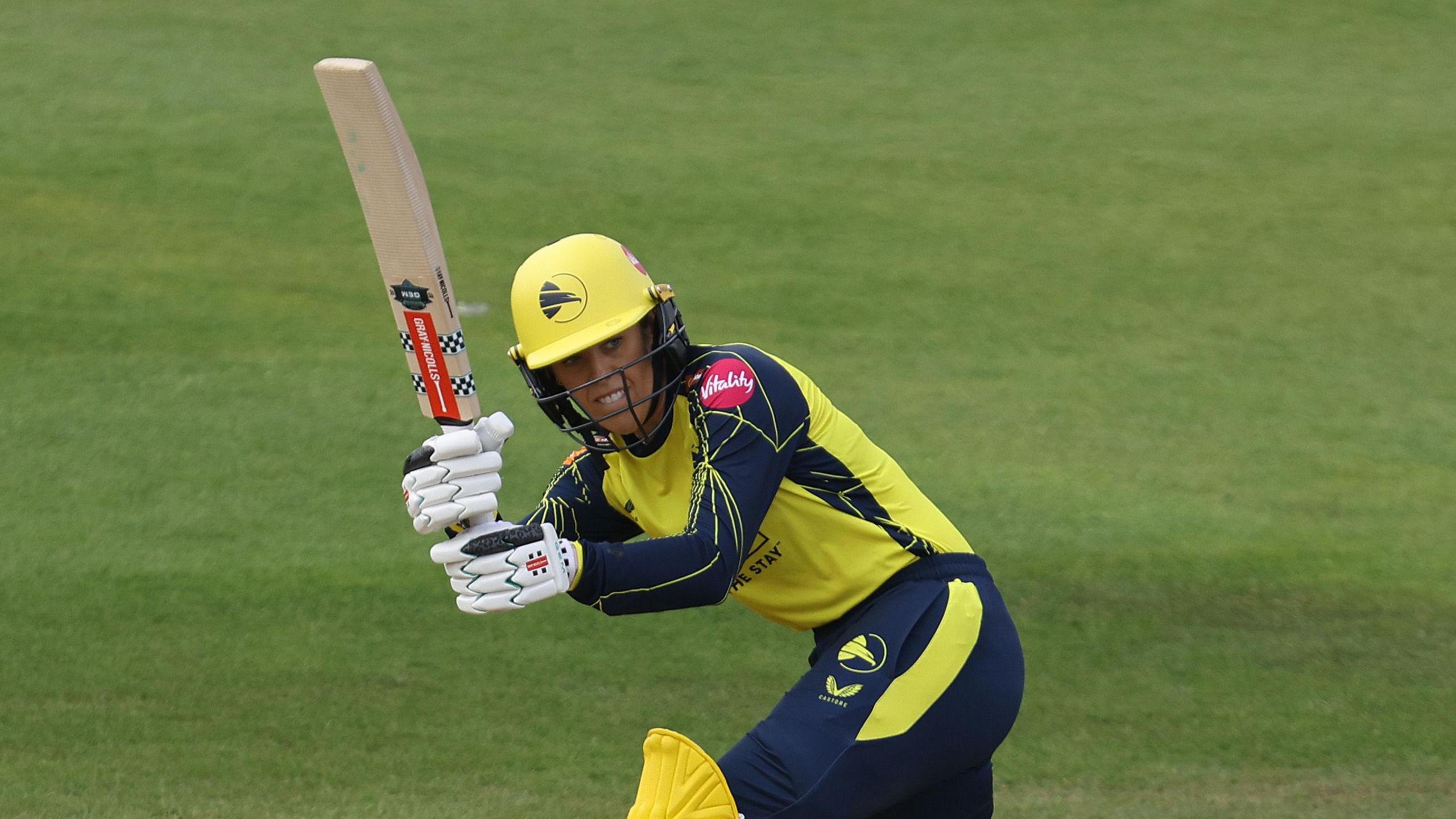 Georgia Adams batting for Hampshire Hawks in their yellow and blue T20 kit