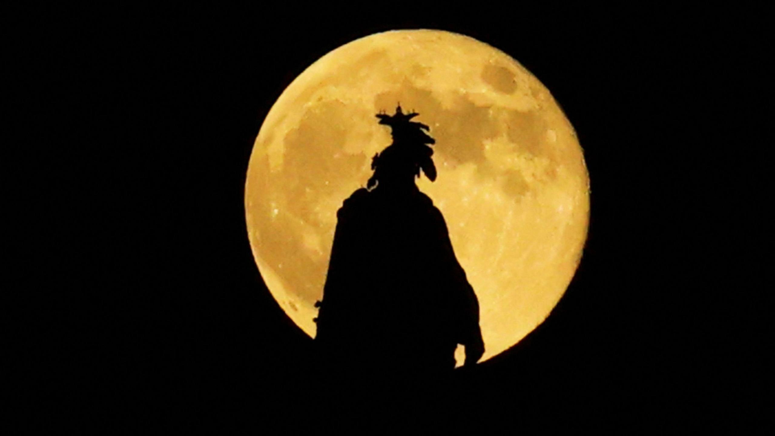 Full moon, known as the Hunter's moon, rises over the Statue of Freedom at the U.S. Capitol building, in Washington, U.S