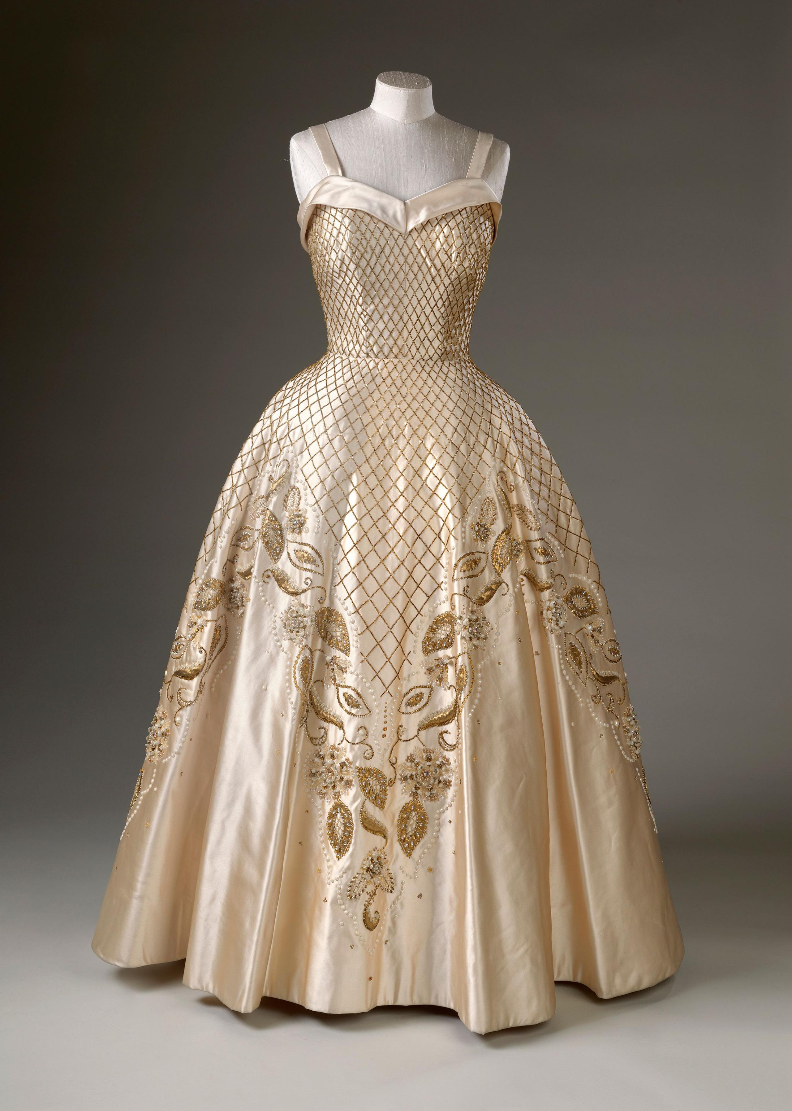 a sleeveless, strapped sweetheart neckline dress with embroidered crosshatching across the bodice and top of the skirt leading into embroidered flowers
