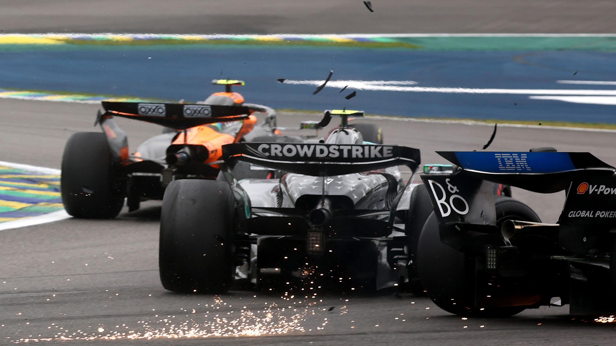 A rear view of the Mercedes of Kimi Antonelli and Ferrari of Charles Leclerc making contact during the Sao Paulo Grand Prix