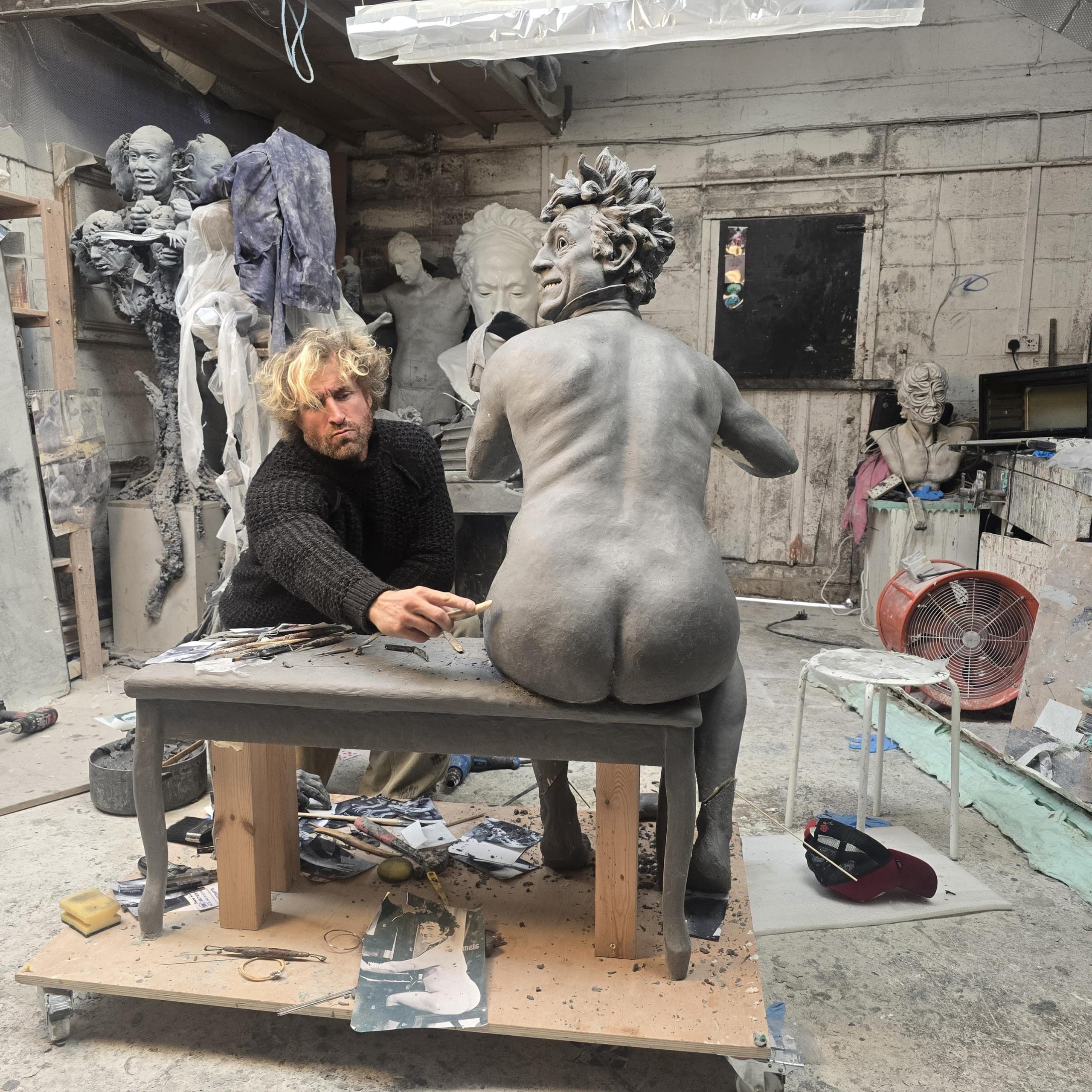 Sculptor Nick Elphick works on the design for the Terry Jones statue in his workshop