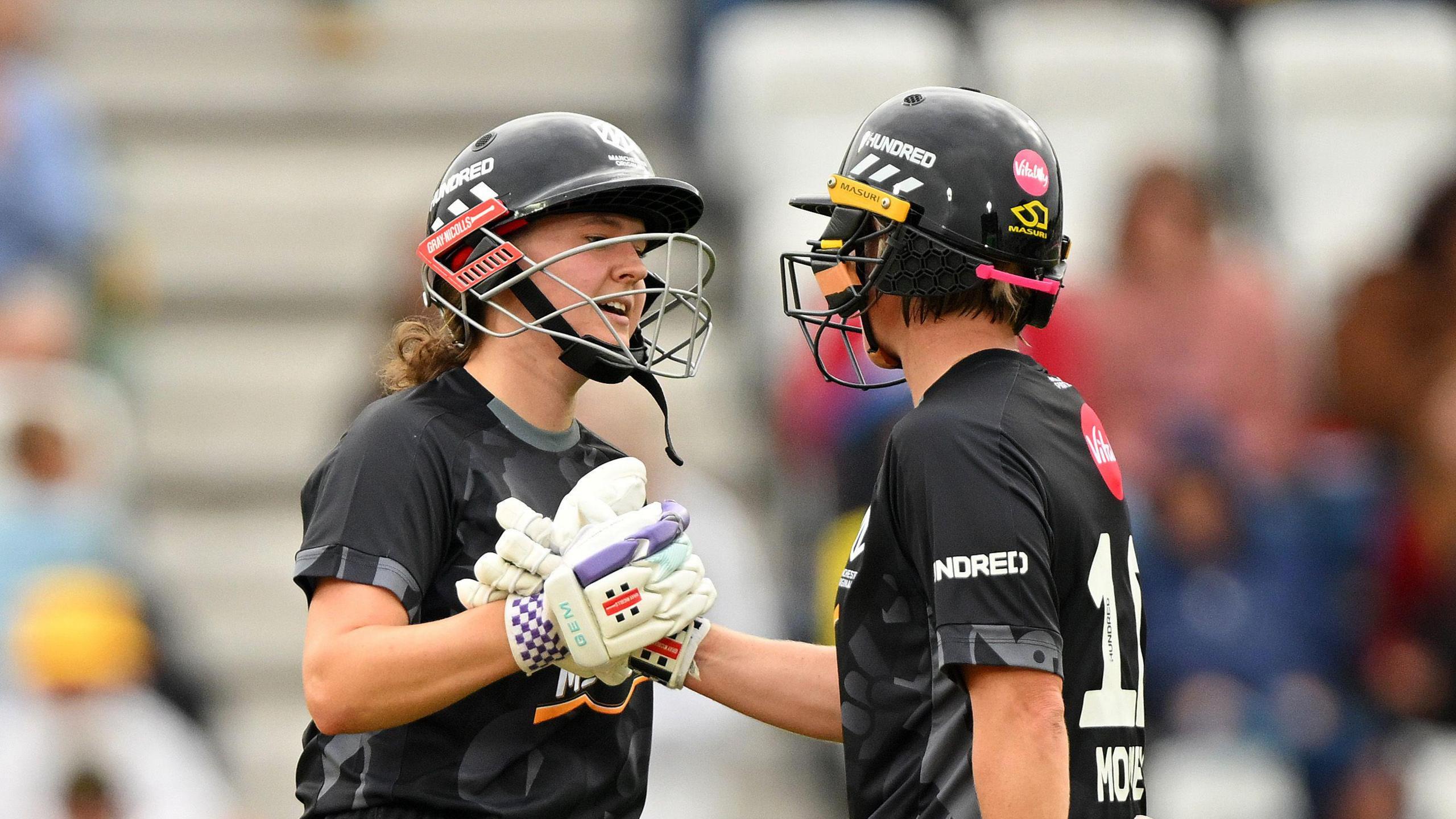 Kathryn Bryce and Beth Mooney shaking hands