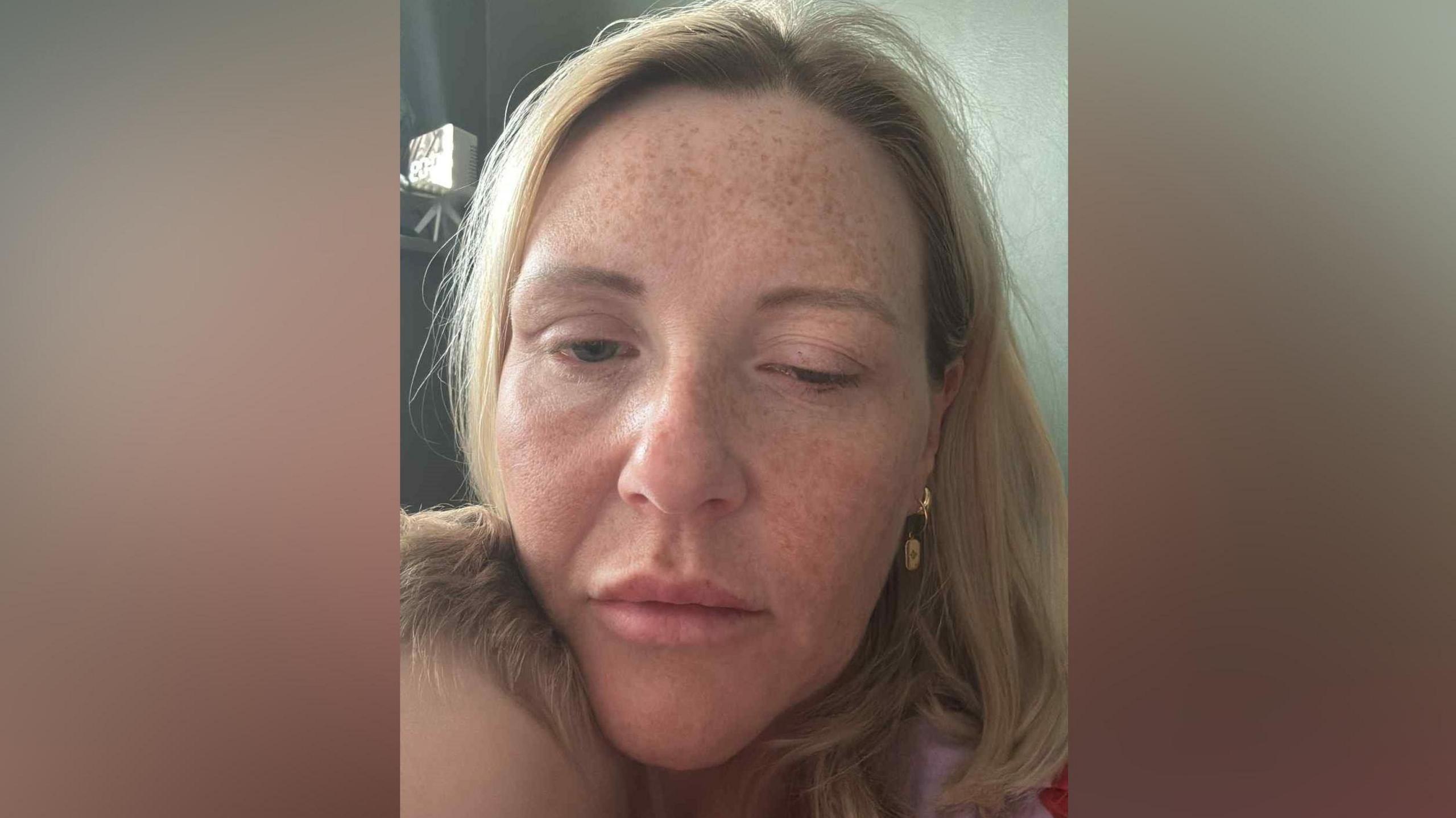 Close-up selfie image of Nicola Fairley, who has shoulder-length blond hair and freckles. Her left eye is almost fully closed.