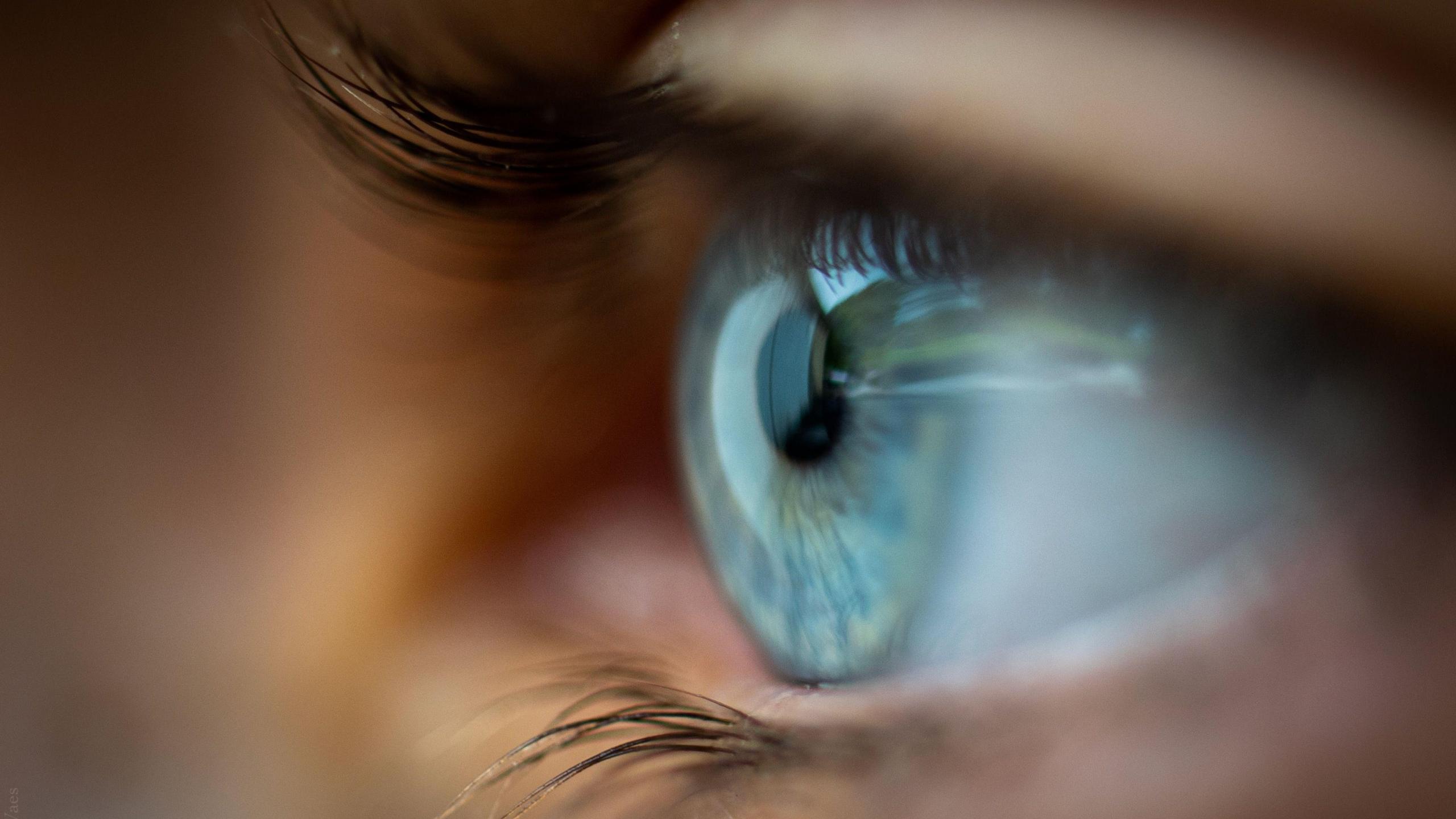 Close up image of an eye and lashes out of focus