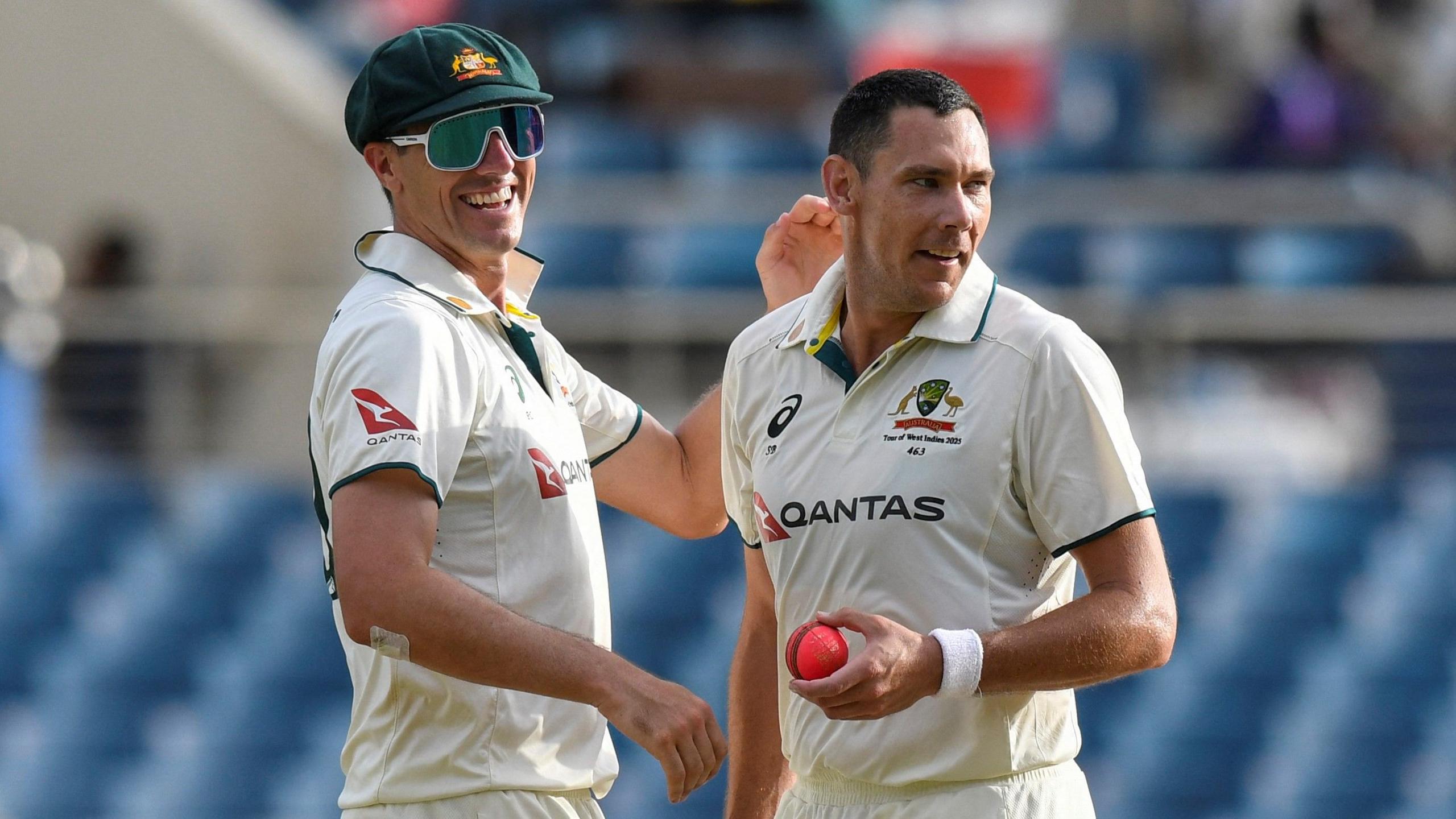 Scott Boland and Pat Cummins celebrate a wicket