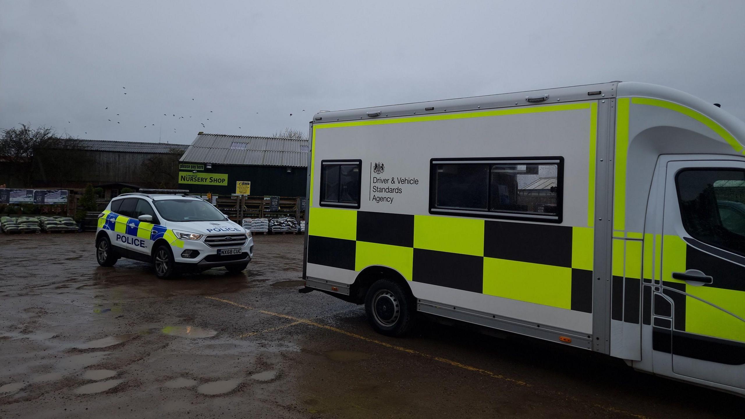 A DVSA van and a police car