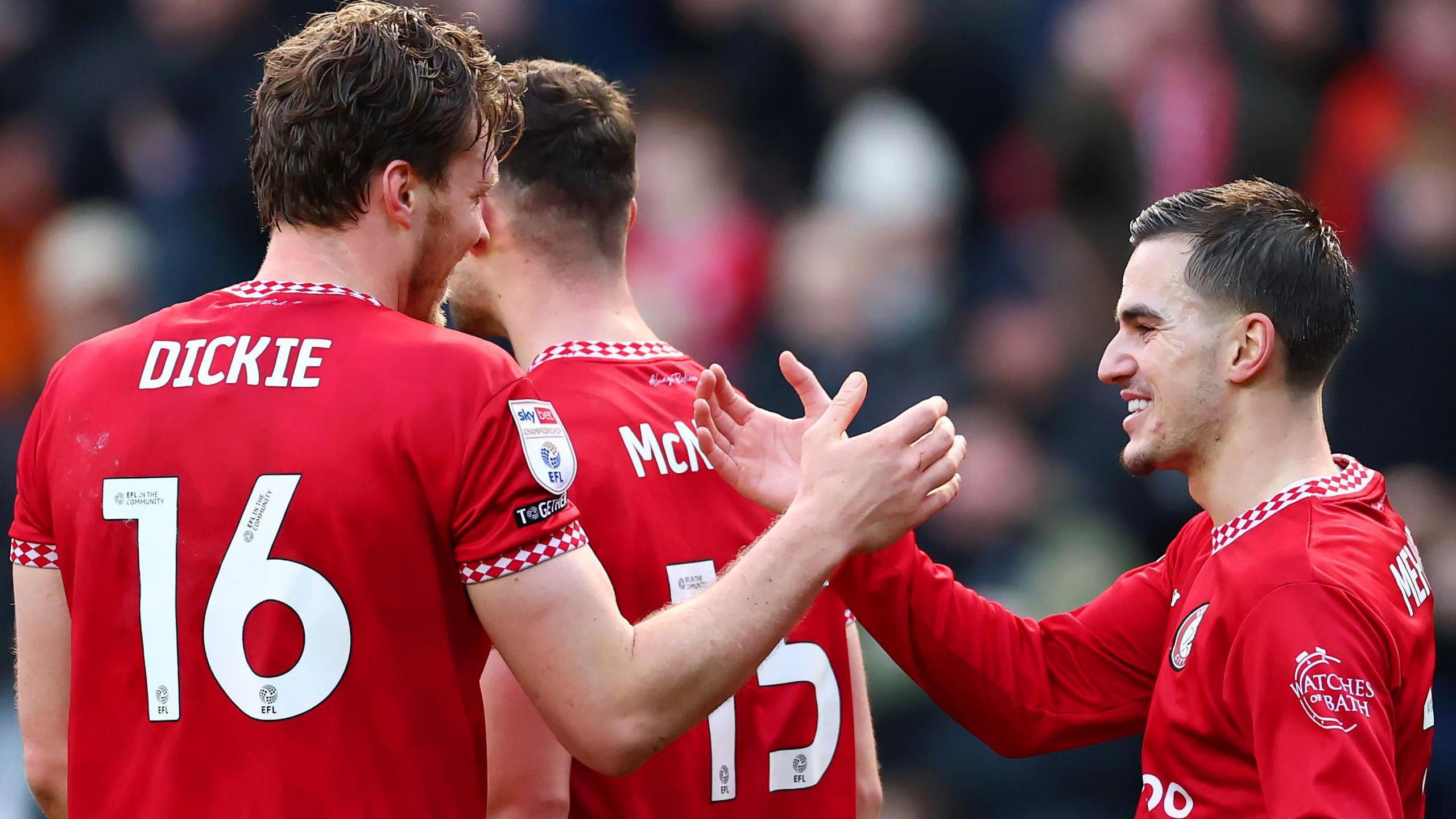 Rob Dickie (left) accepts the congratulations from his Bristol City team-mates after scoring his side's third goal against Portsmouth