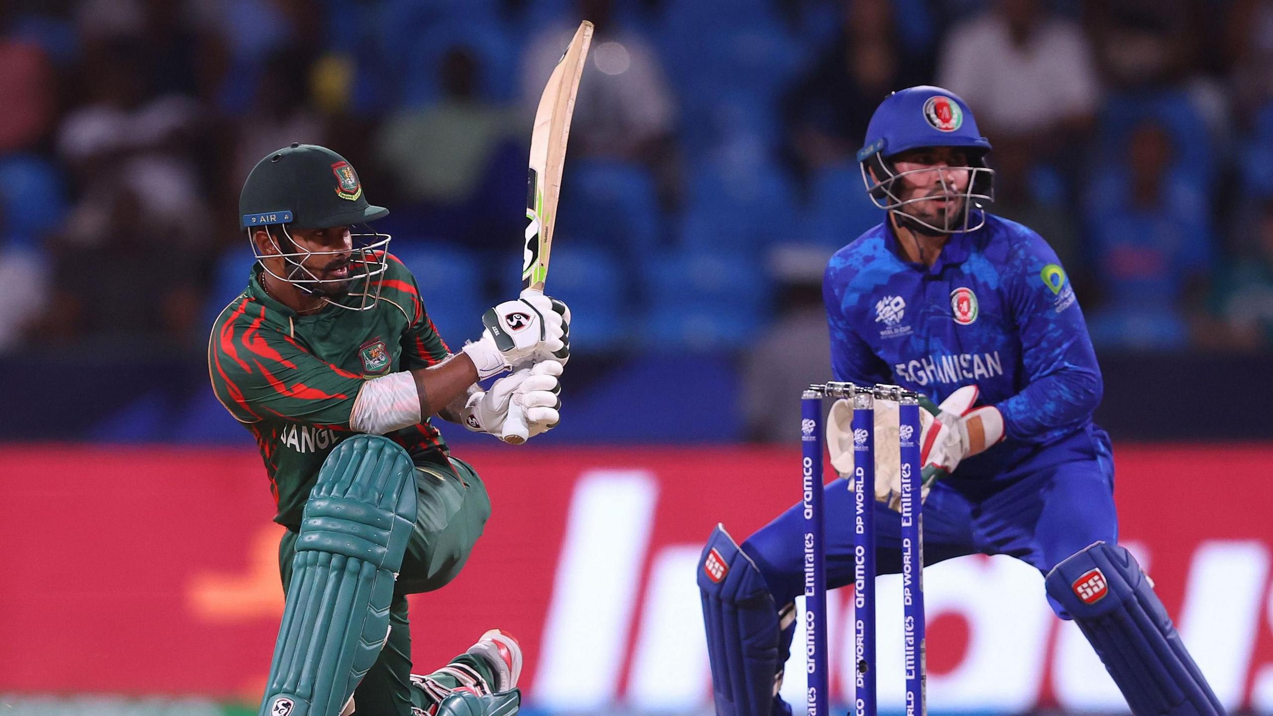 Bangladesh's Litton Das hits out, watched by Afghanistan wicketkeeper Mohammad Ishaq