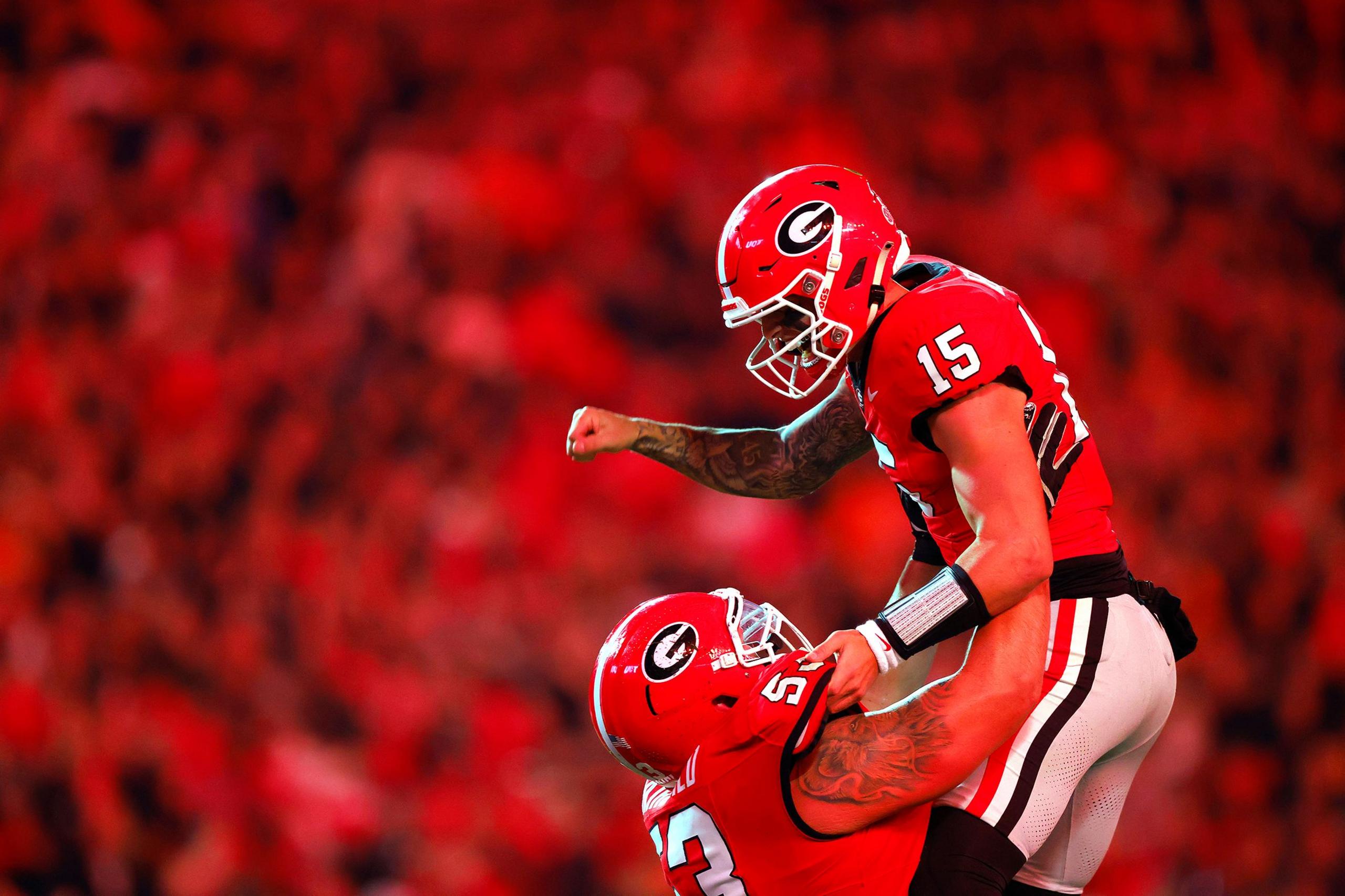 Carson Beck and Dylan Fairchild of the Georgia Bulldogs celebrate after a touchdown during the second quarter against the Tennessee Volunteers at Sanford Stadium on 16 November 2024 in Athens, Georgia.