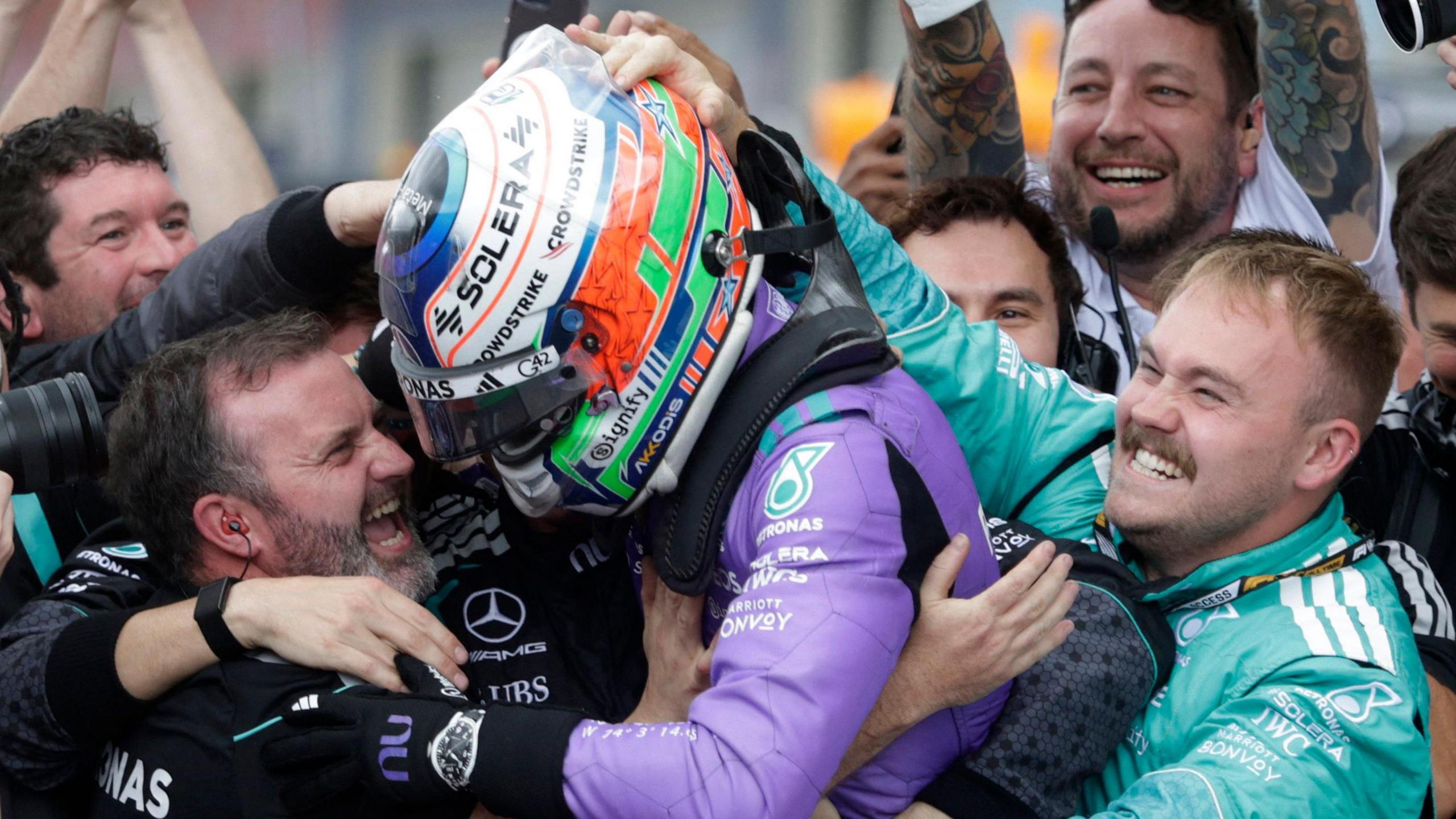 Kimi Antonelli celebrates with members of his Mercedes team after winning the Miami Grand Prix