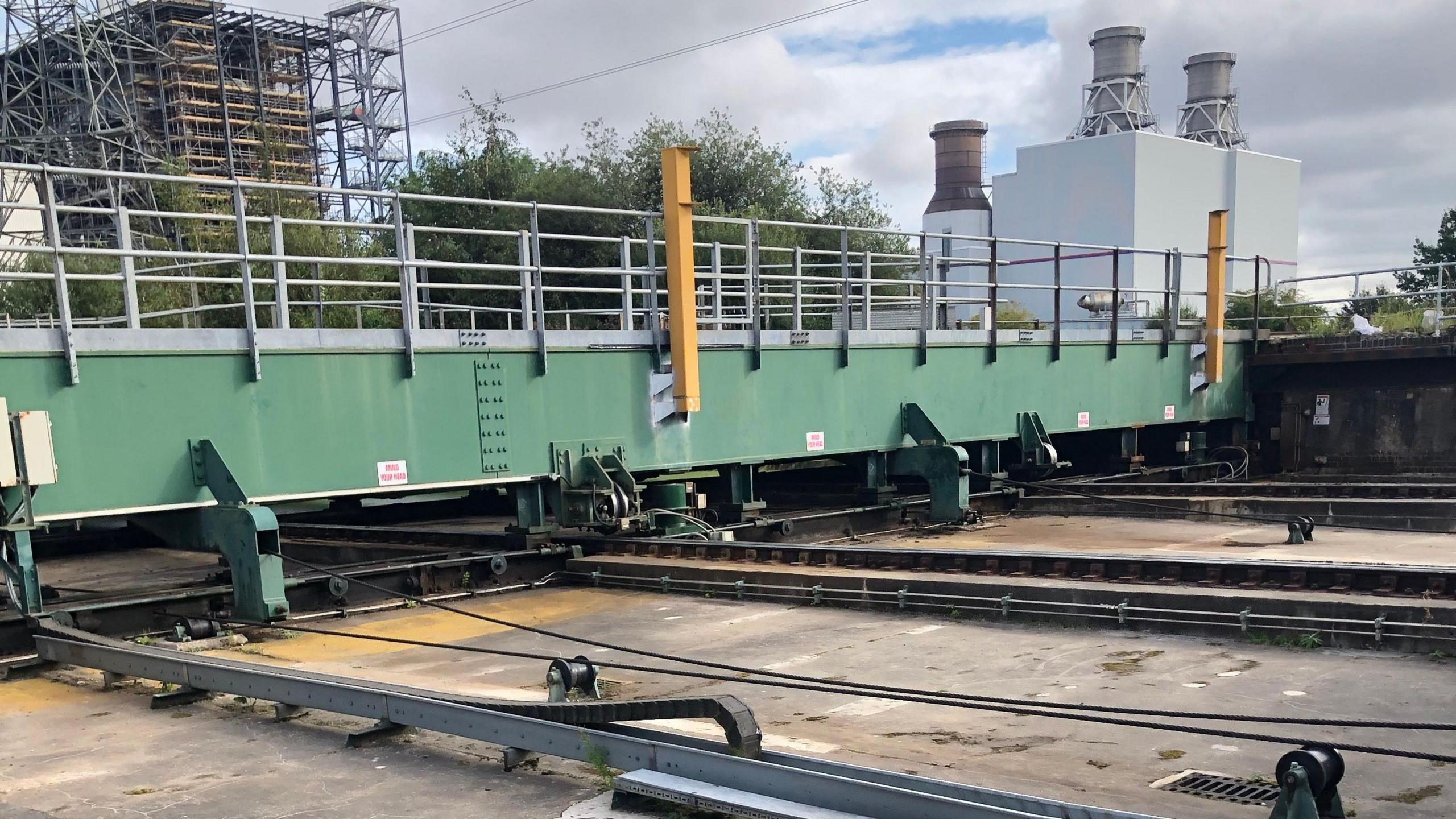 Close-up of green metal barriers going across metal tracks