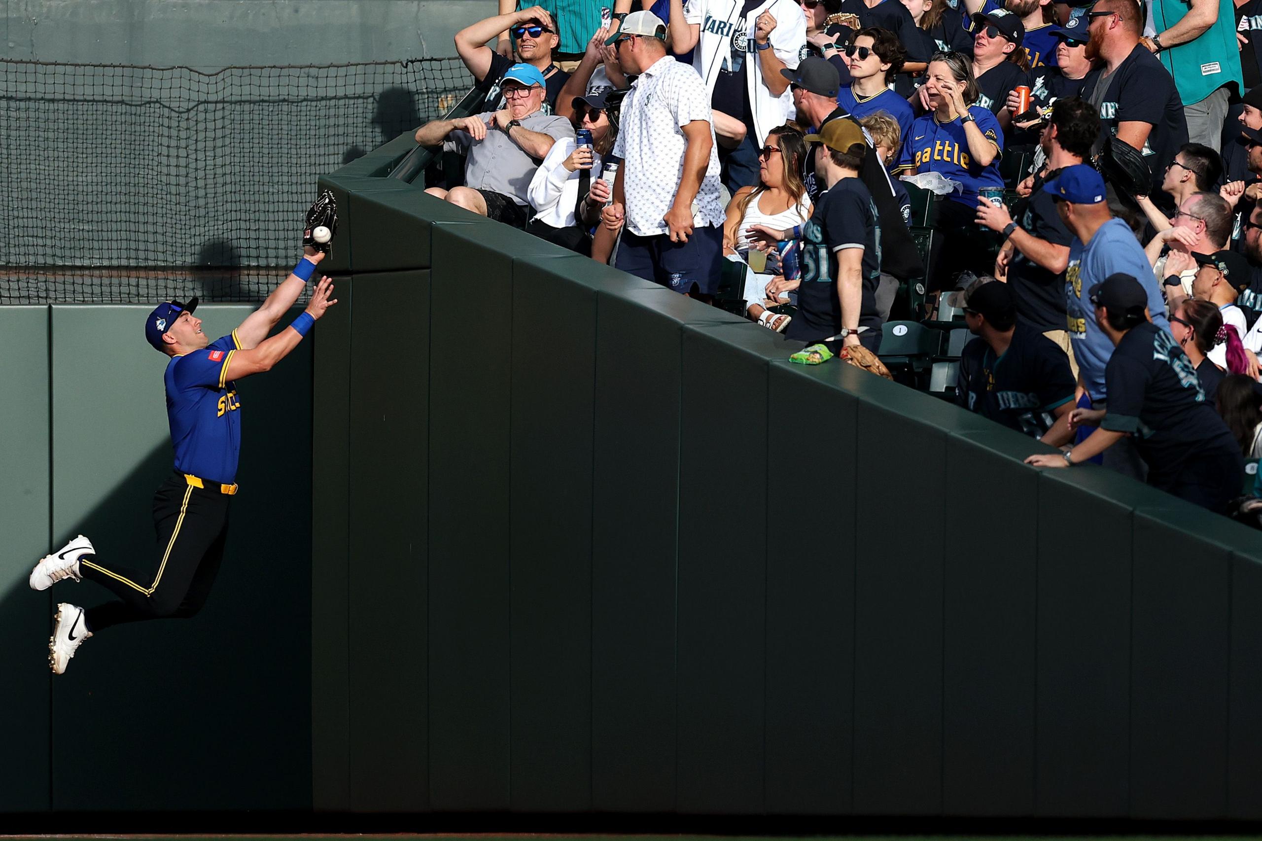 Seattle Mariners' Dominic Canzone leaps for a foul ball during the first inning against the Tampa Bay Rays at T-Mobile Park in Seattle, Washington. Photo by Steph Chambers
