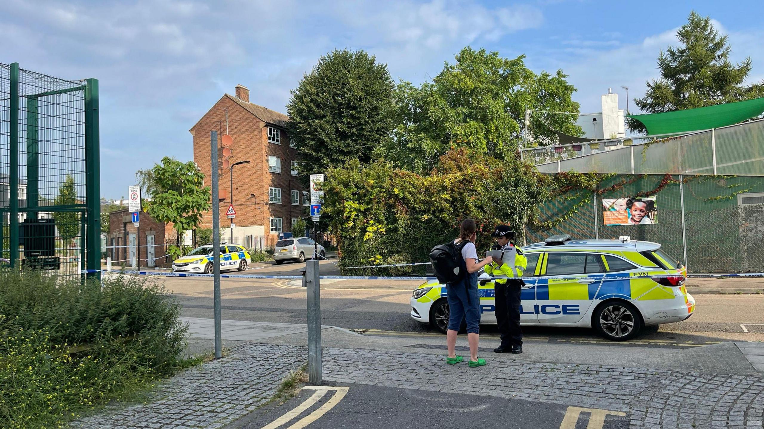 A police officer speaks to a person 