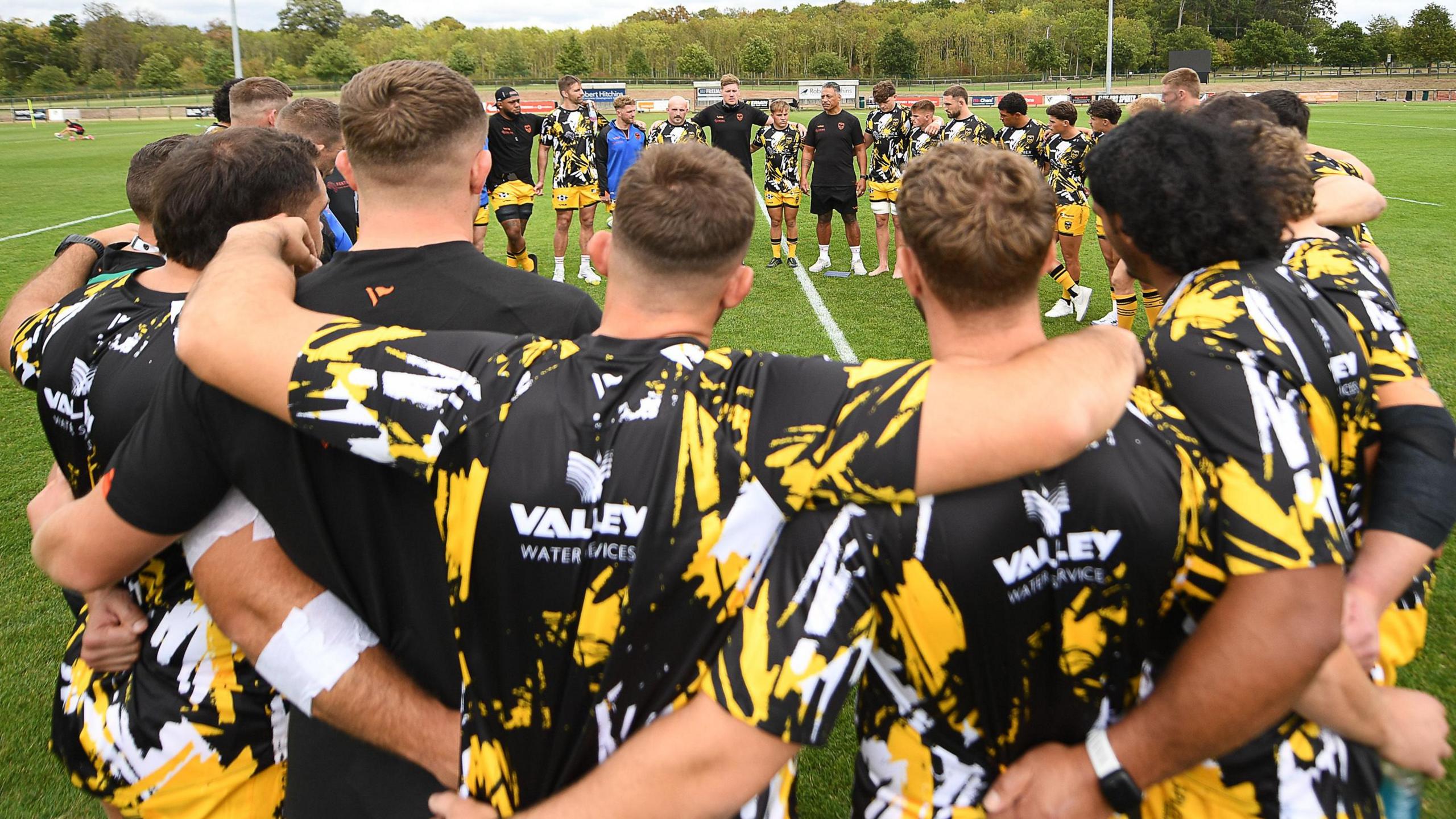 Dragons players in a huddle
