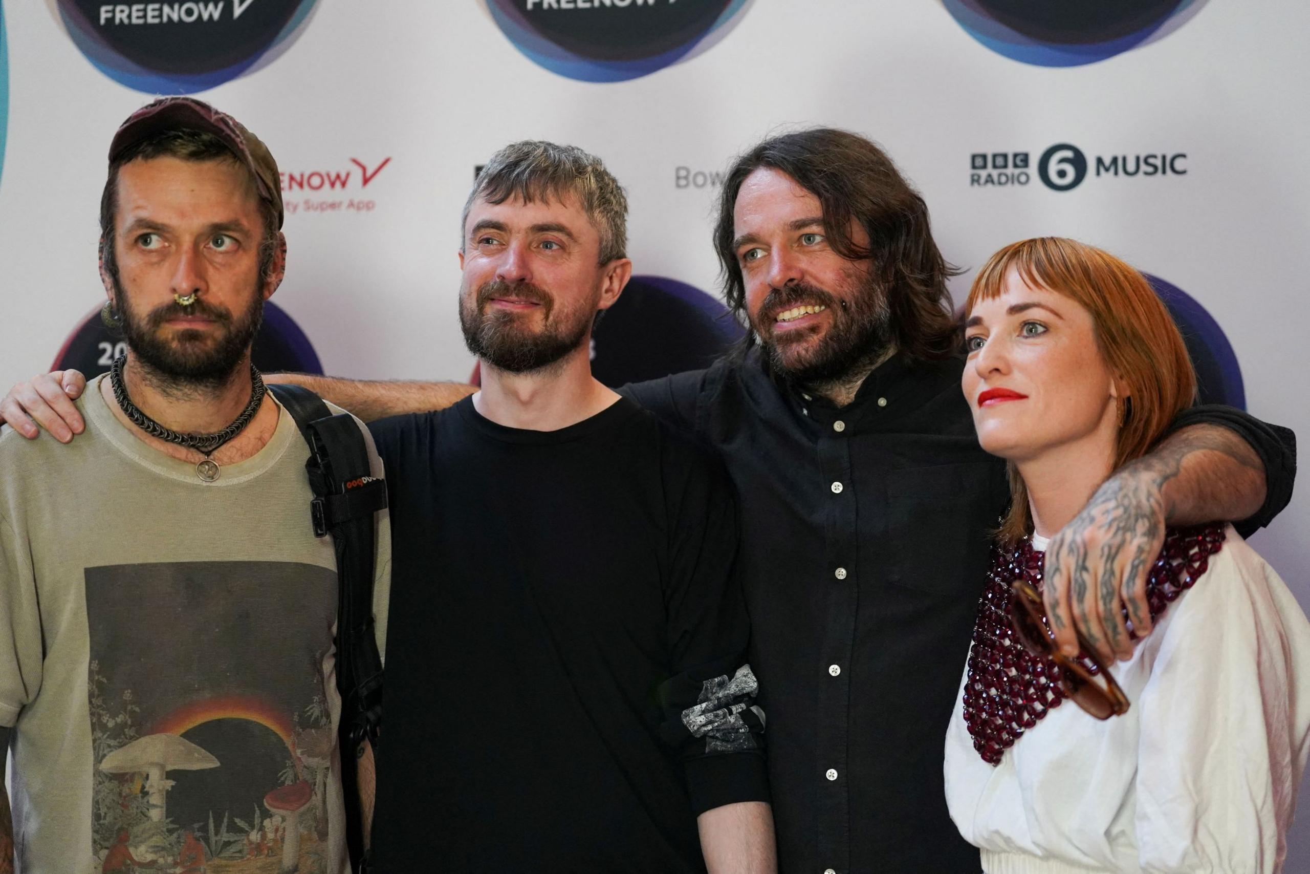 The band Lankum posing together - they are three men and one woman