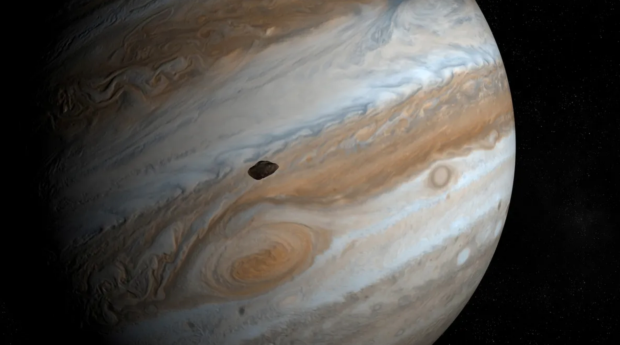 Artist's illustration of Amalthea orbiting Jupiter.